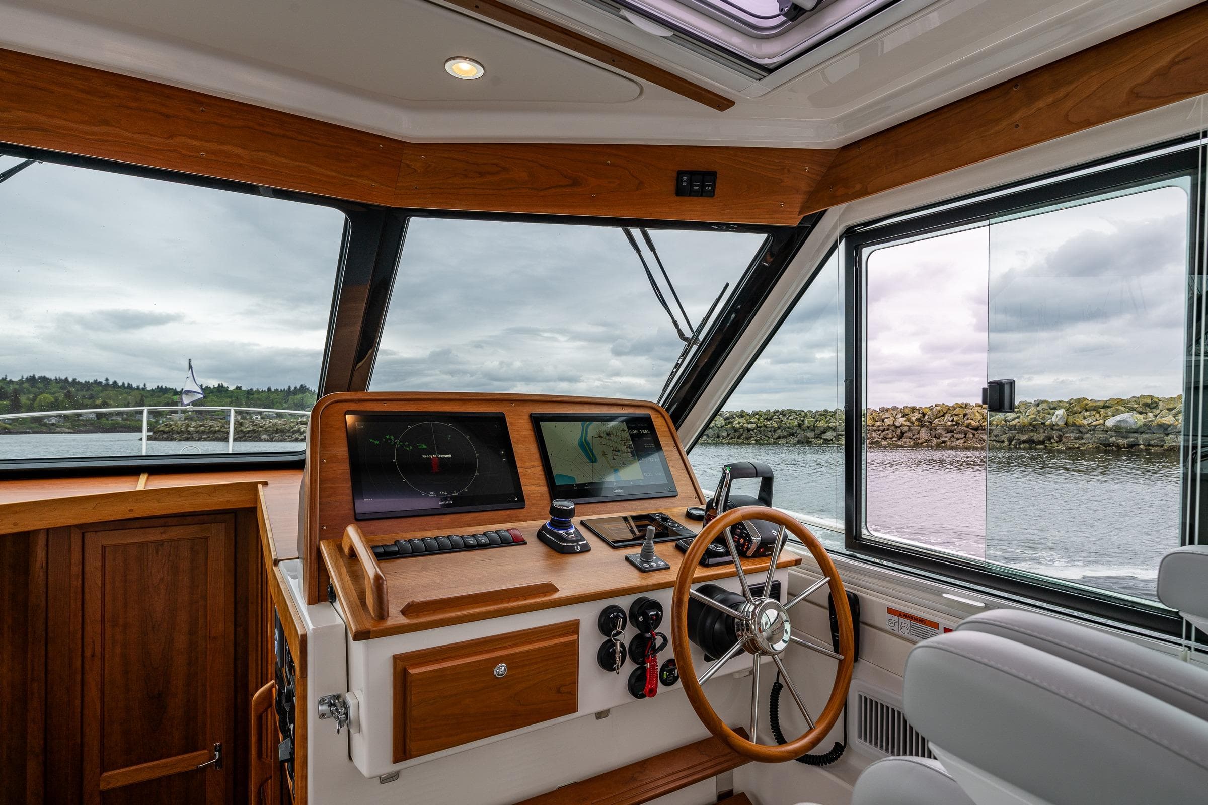 Interior view of 2025 Back Cove 39O boat helm with modern navigation equipment.