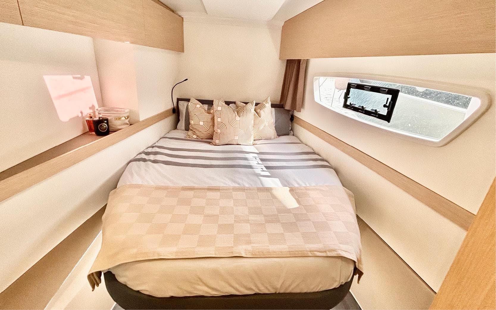 Luxurious cabin interior of 2023 Fountaine Pajot Astrea 42 catamaran with cozy bedding.