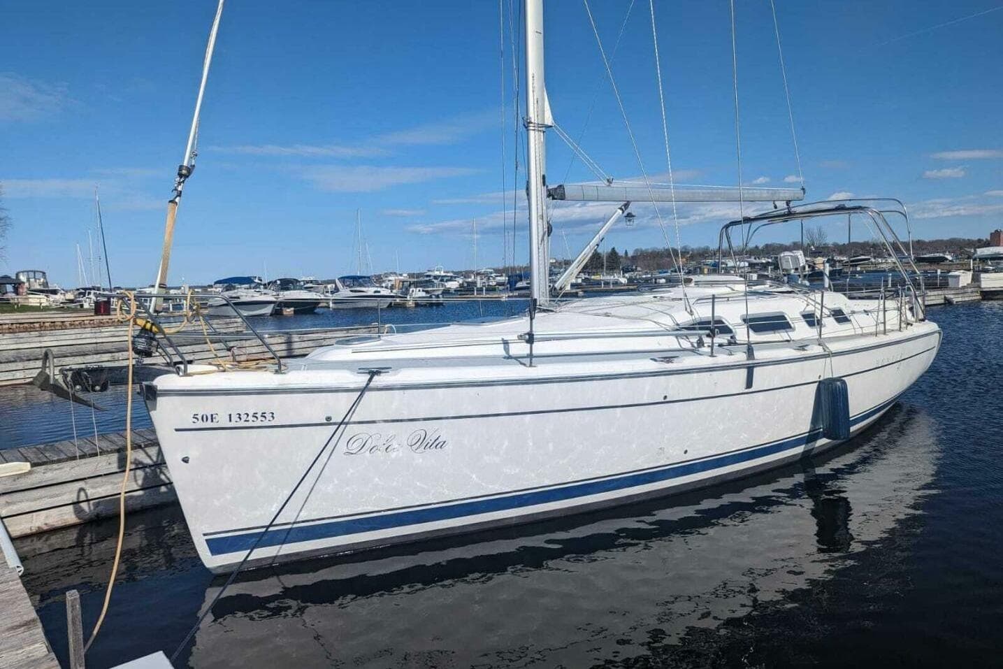 2004 Hunter 41 AC sailboat docked in a marina under a clear blue sky.