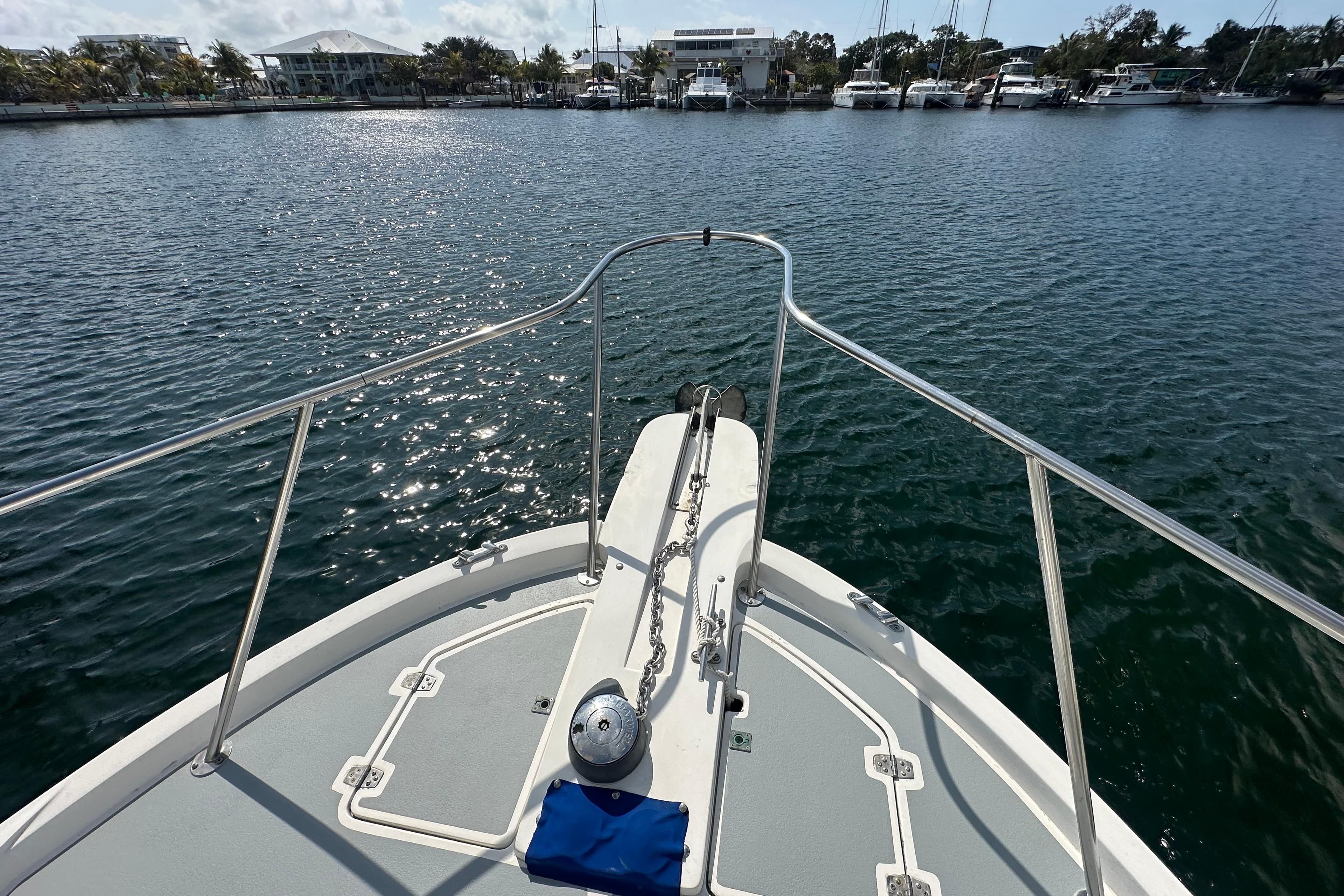 Bow view of 1991 Carver Californian 48 yacht in a marina setting.
