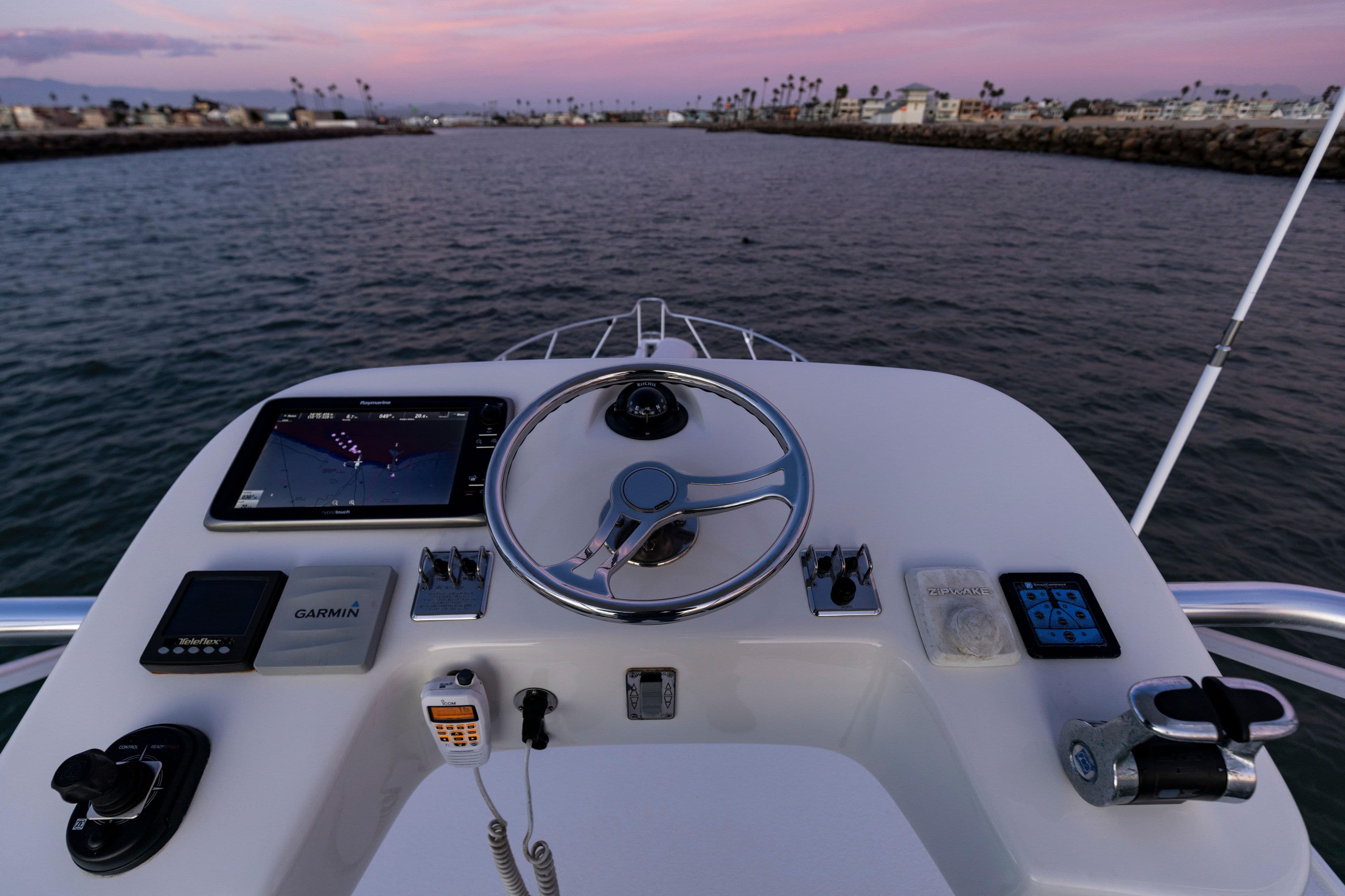 Cabo 36 Express 2013 boat helm with navigation equipment at sunset.