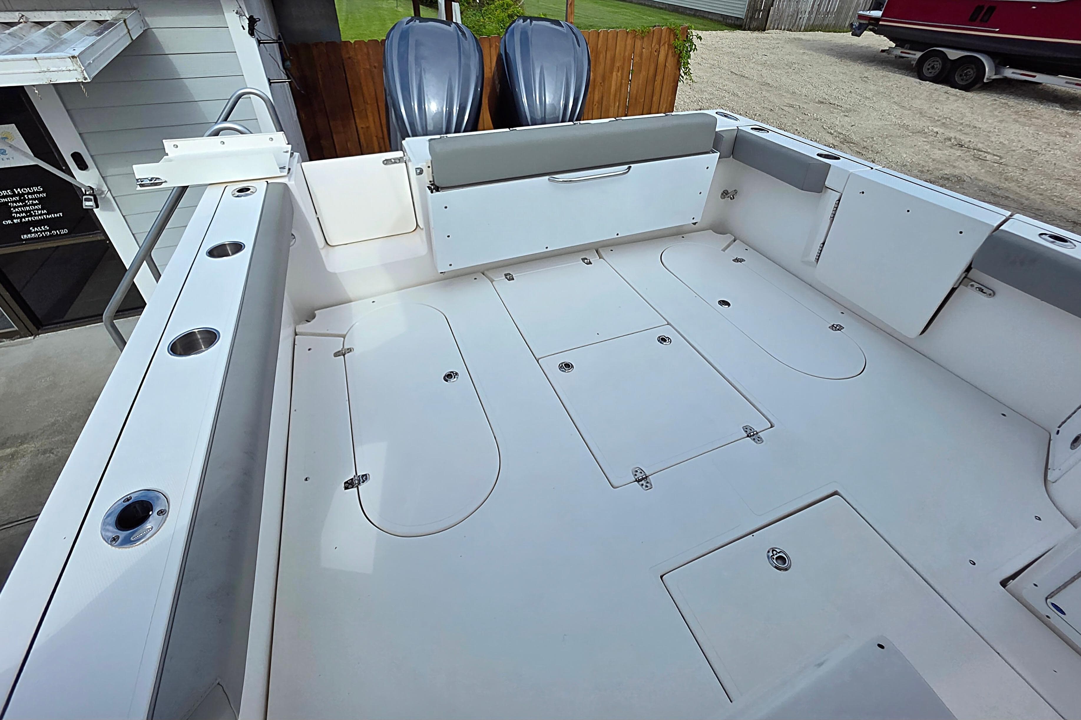 2024 NorthCoast 315 HT boat deck with storage compartments and rod holders.
