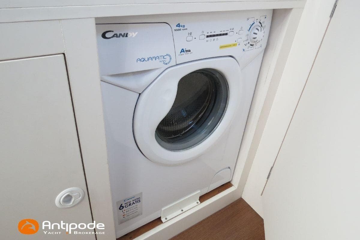Compact Candy Aquamatic washing machine in a yacht's laundry area, model JPB 52, 2021.