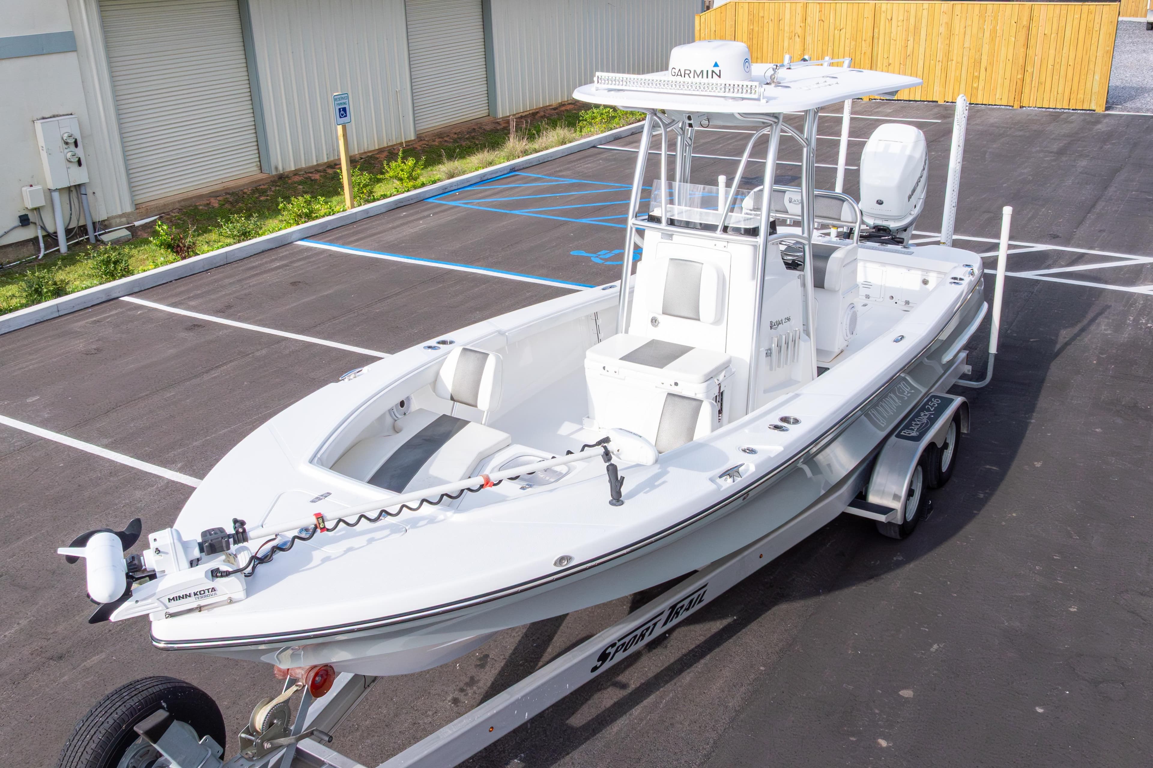 2022 BlackJack 256 Coastal boat on trailer in parking lot, featuring Garmin equipment.
