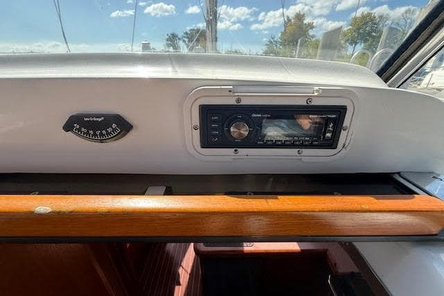 Control panel of a 2005 Hunter 38 sailboat with stereo and compass.