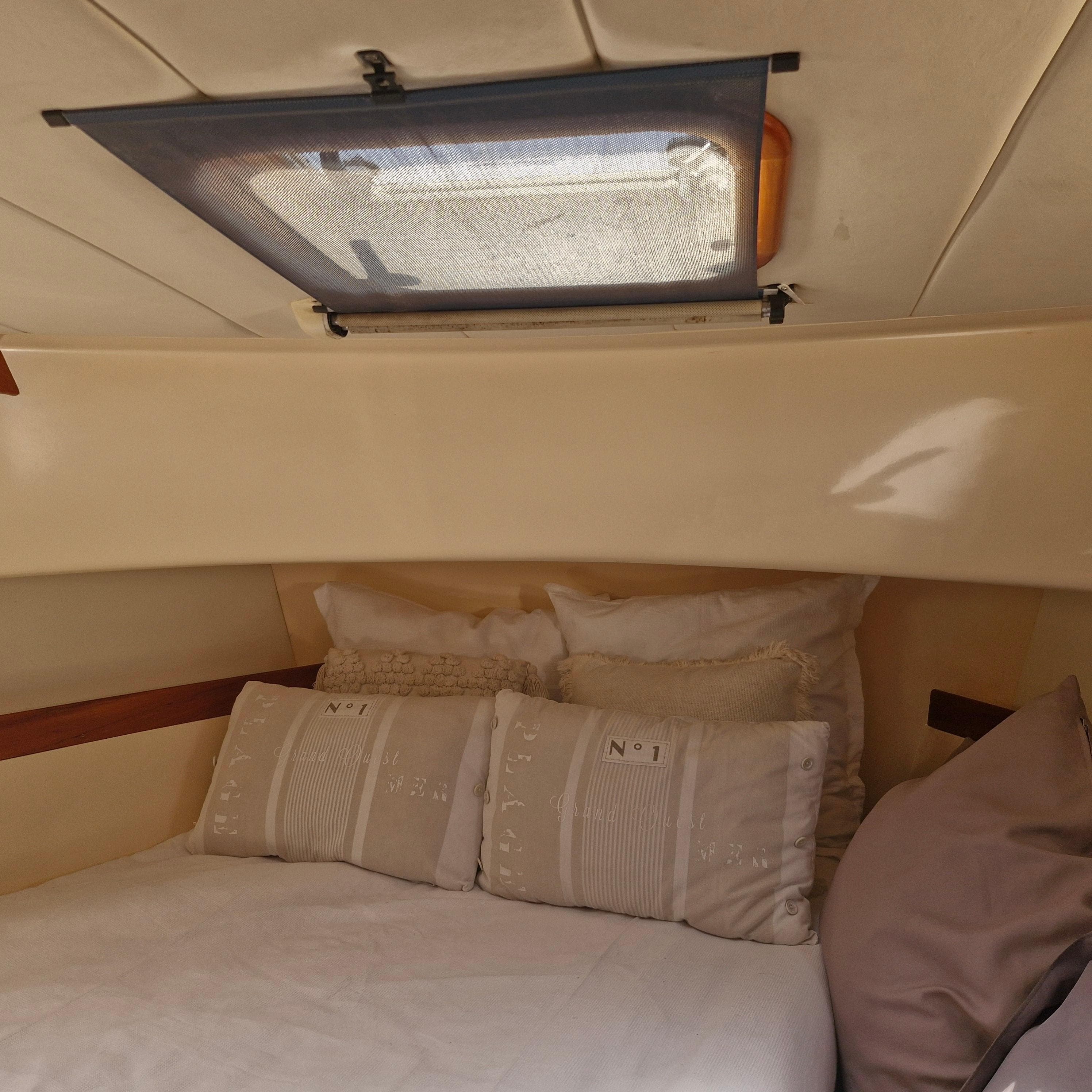 Cozy cabin interior of 2001 Apreamare 10 Cabinato with comfortable bedding.