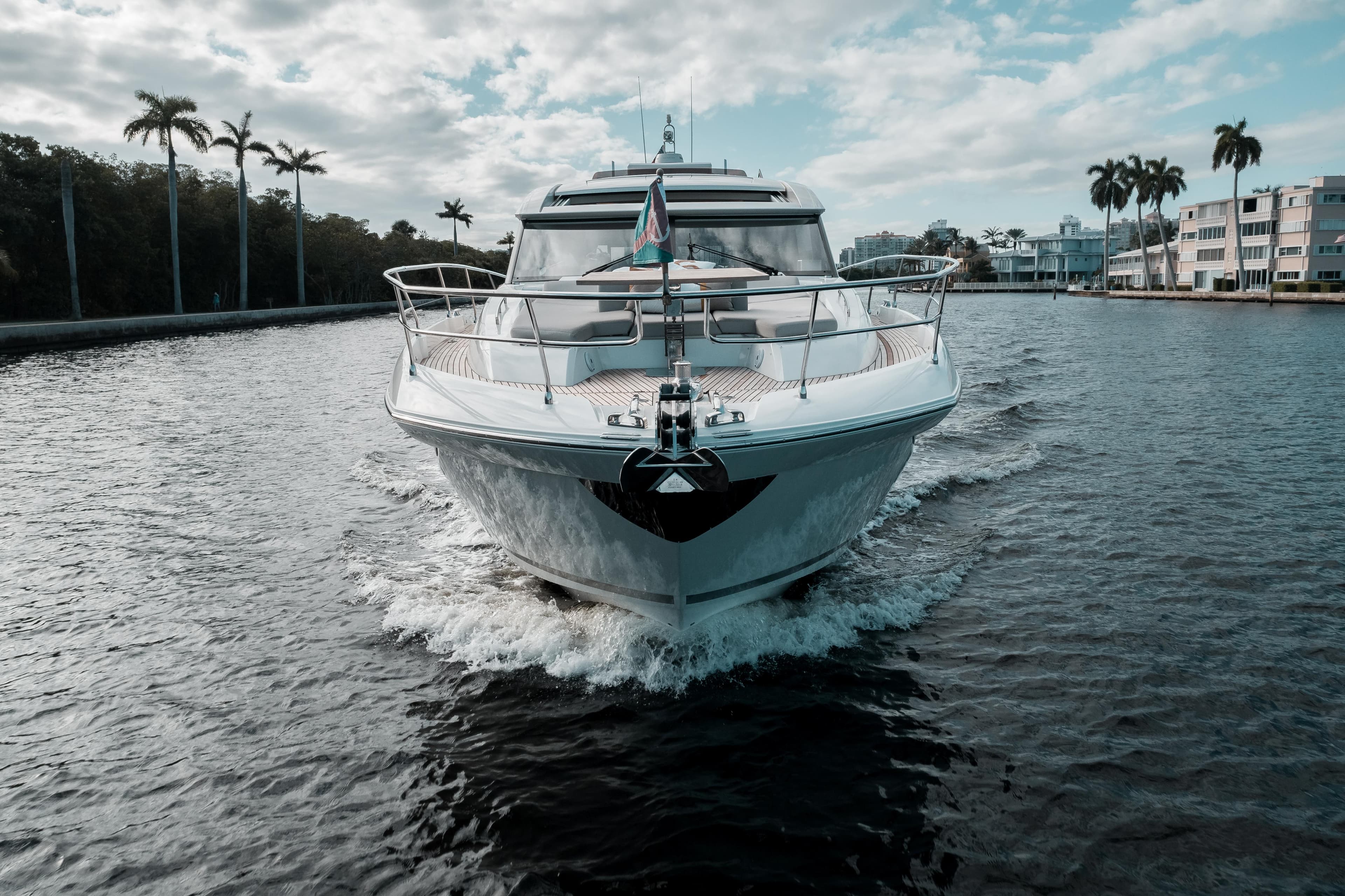 2019 Prestige 590 S yacht cruising on a scenic waterway.