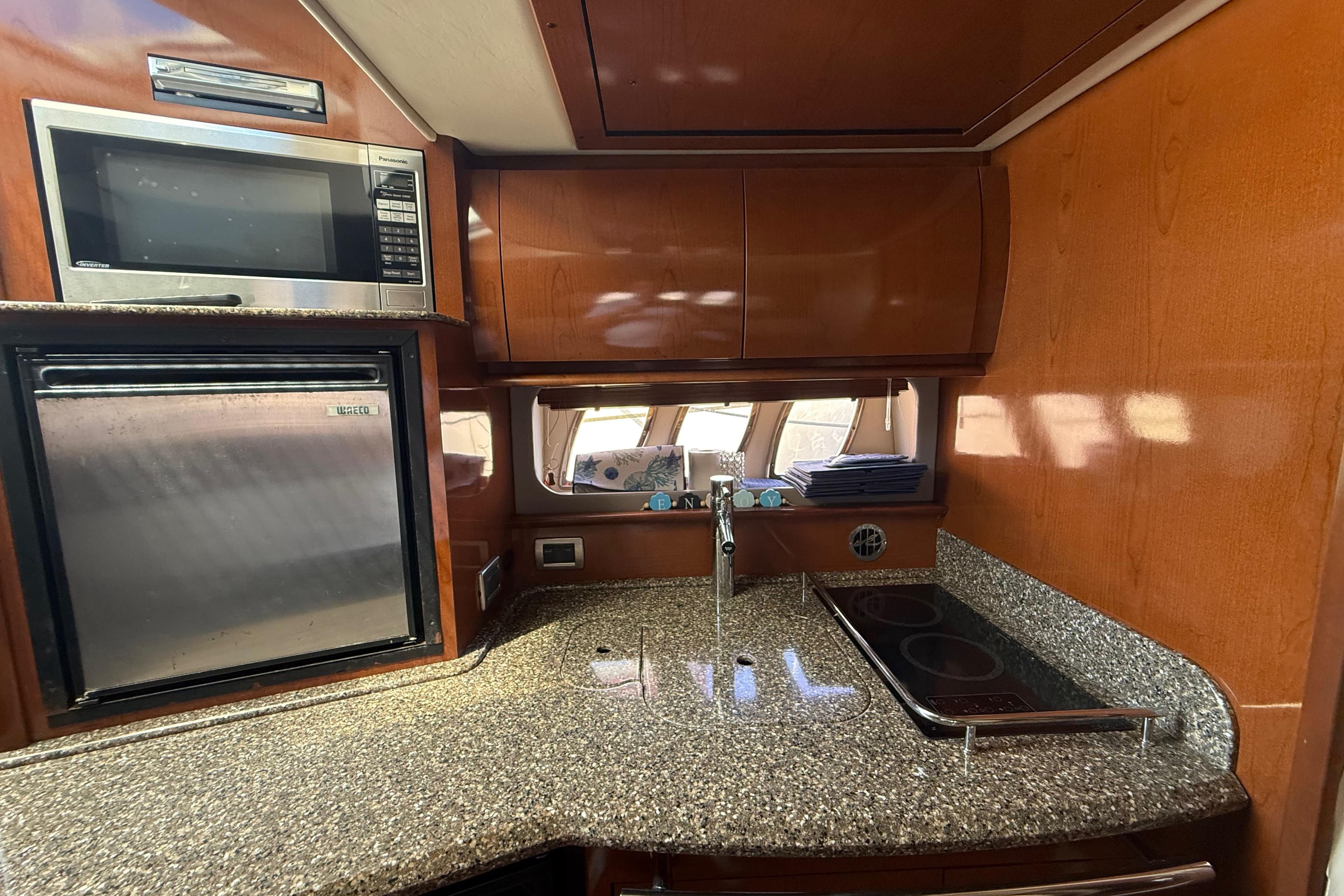 Luxurious kitchen area in a 2008 Sea Ray 38 Sundancer yacht with modern appliances.