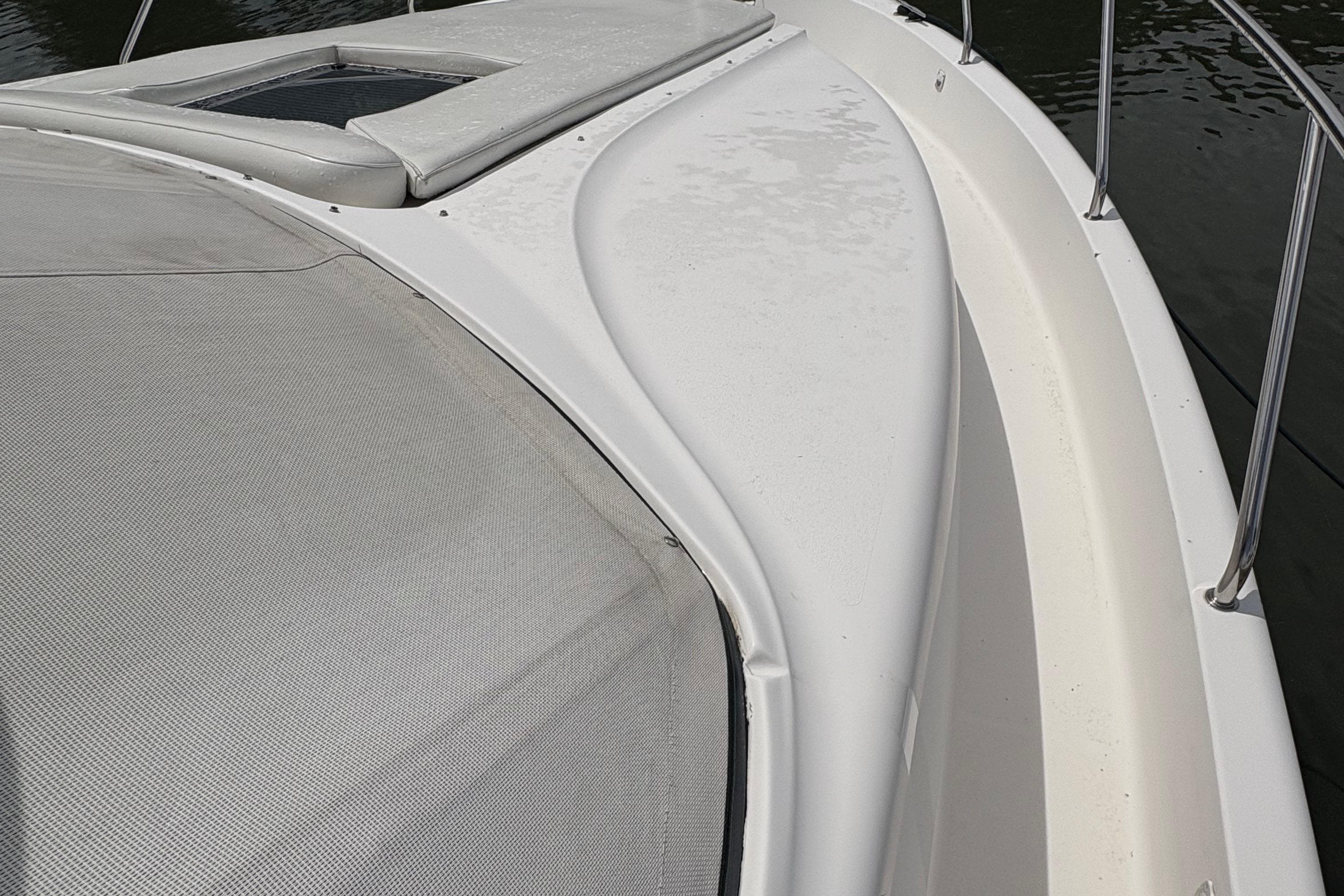 1999 Silverton 392 yacht deck with sleek design and railing, on calm water.