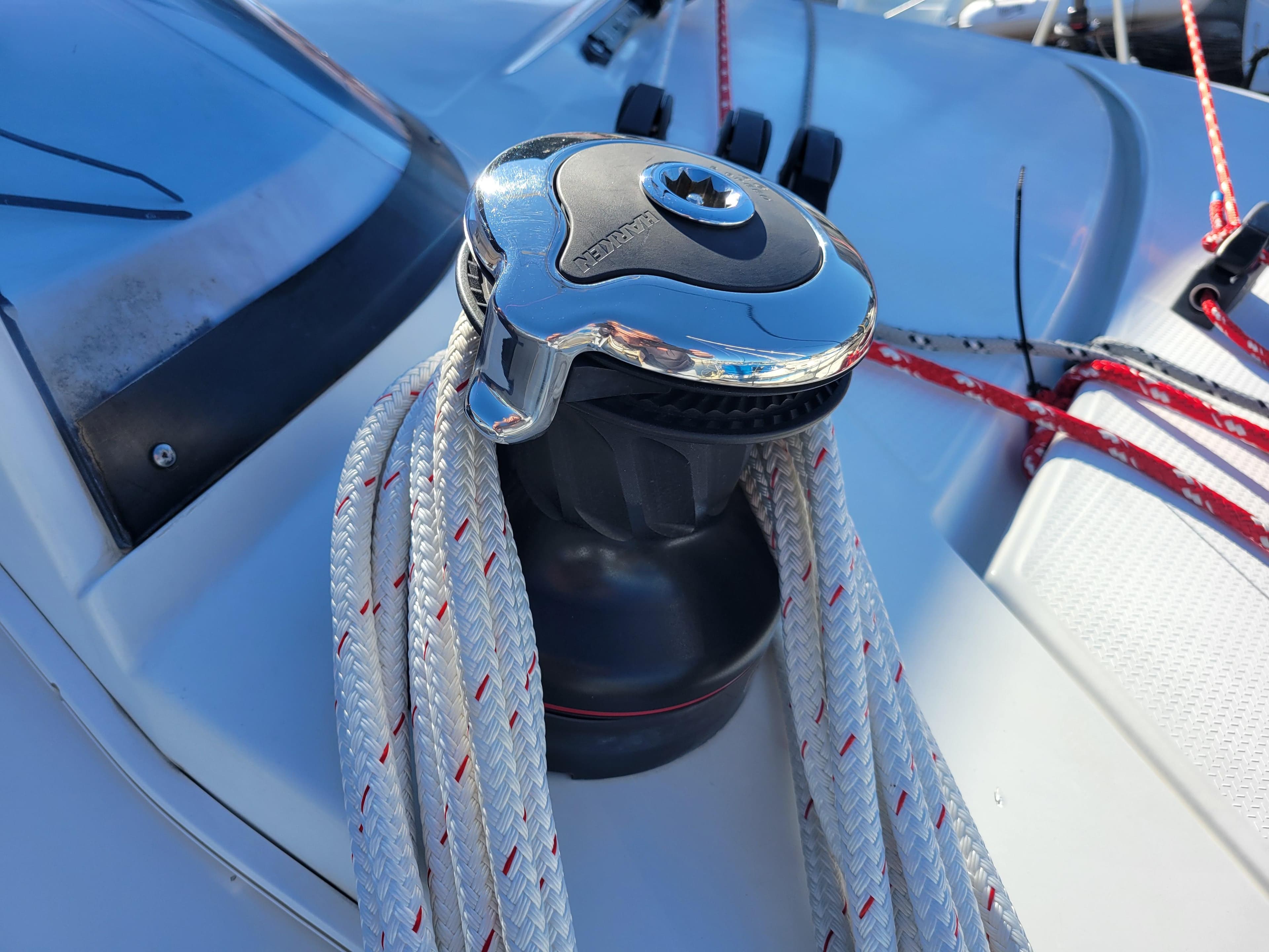 Winch on 2006 Fountaine Pajot LAVEZZI catamaran with ropes, close-up view.
