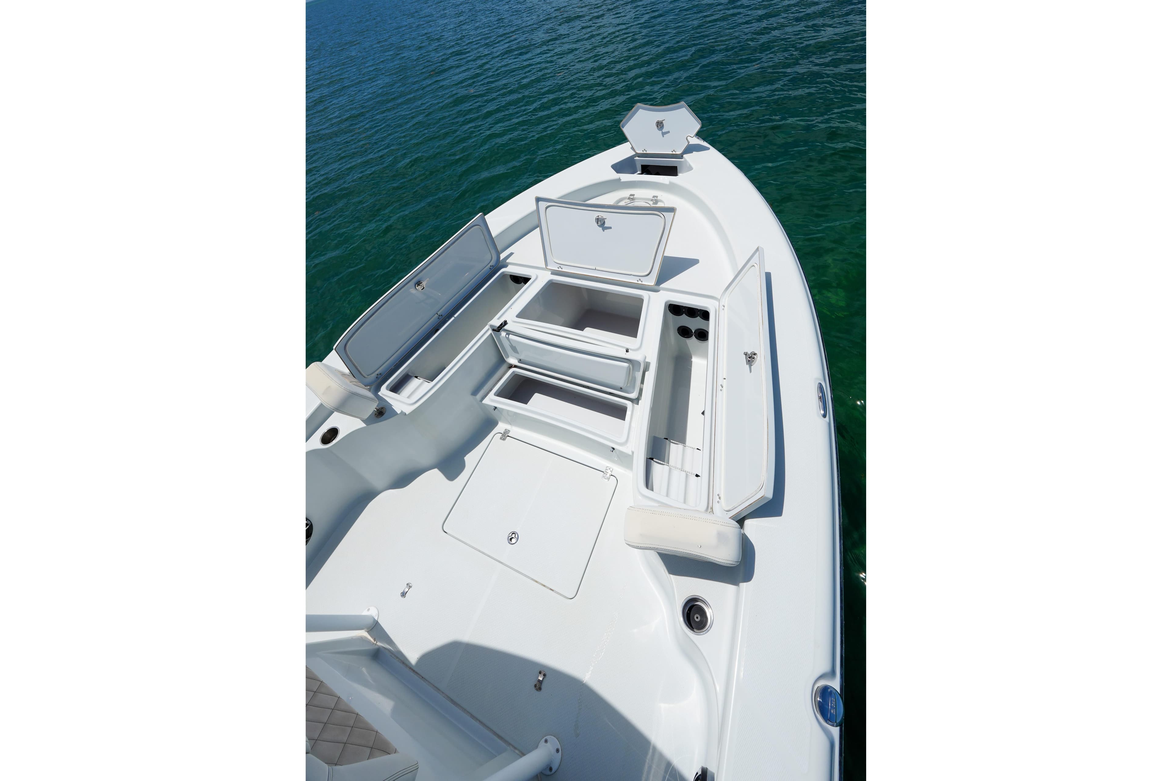 2019 Blue Wave 2800 Pure Hybrid boat with open storage compartments on calm water.