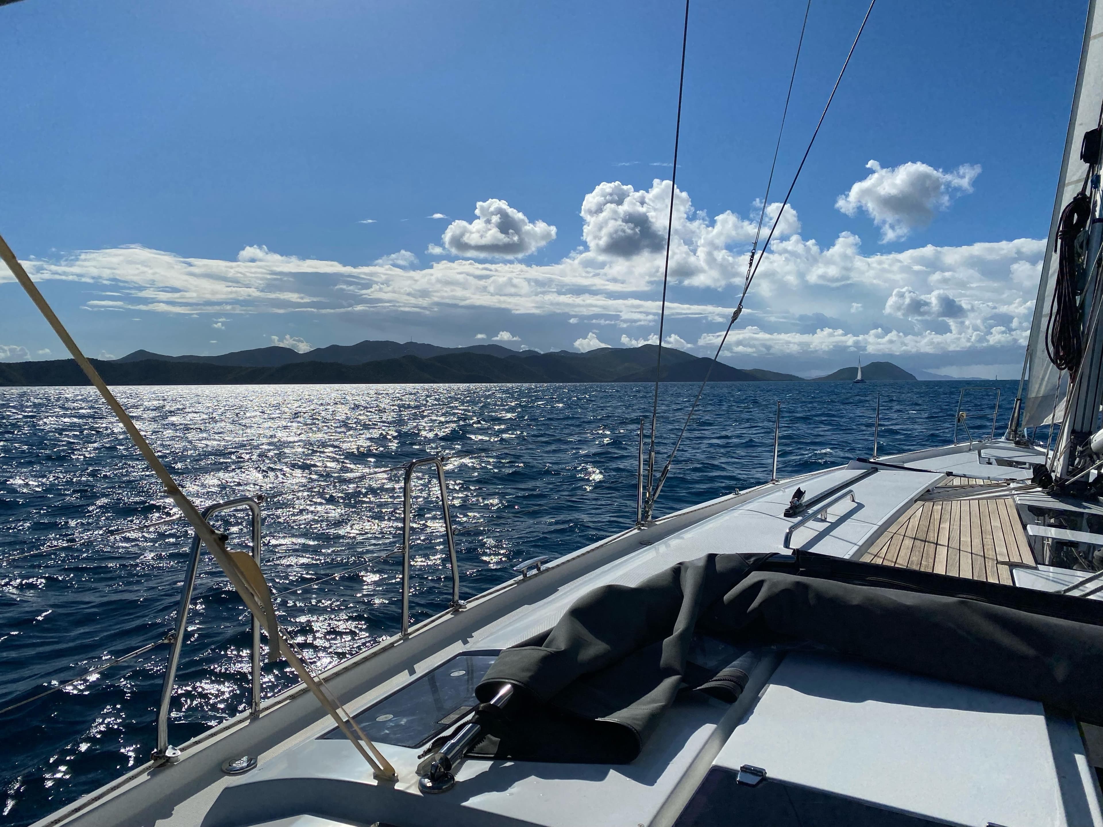 Sailing on a 2016 Hanse 505 yacht with scenic ocean and mountain views.