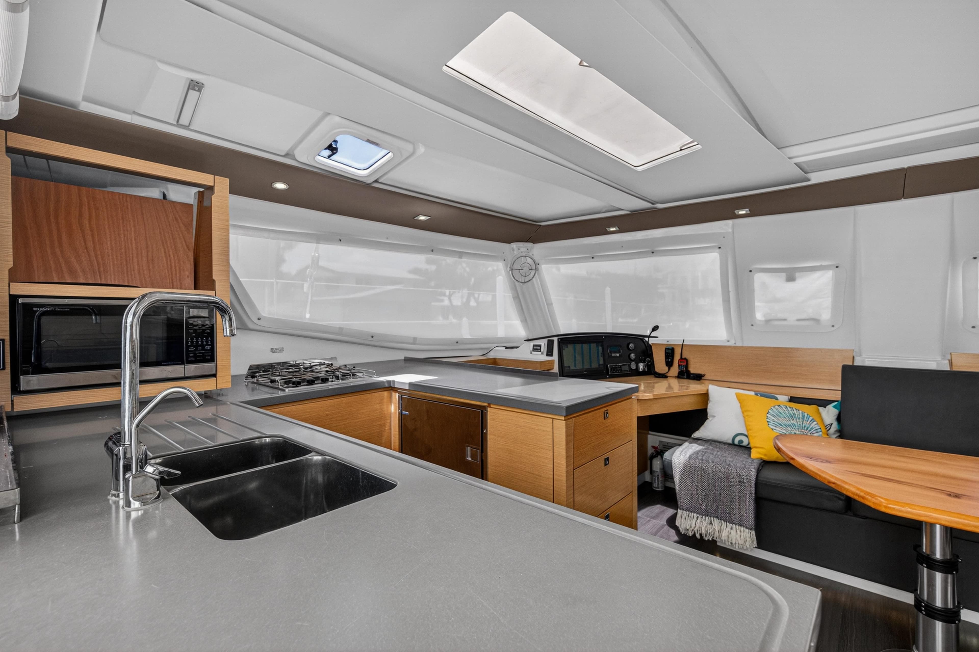 Interior of 2015 Fountaine Pajot Helia 44 catamaran with modern kitchen and seating area.