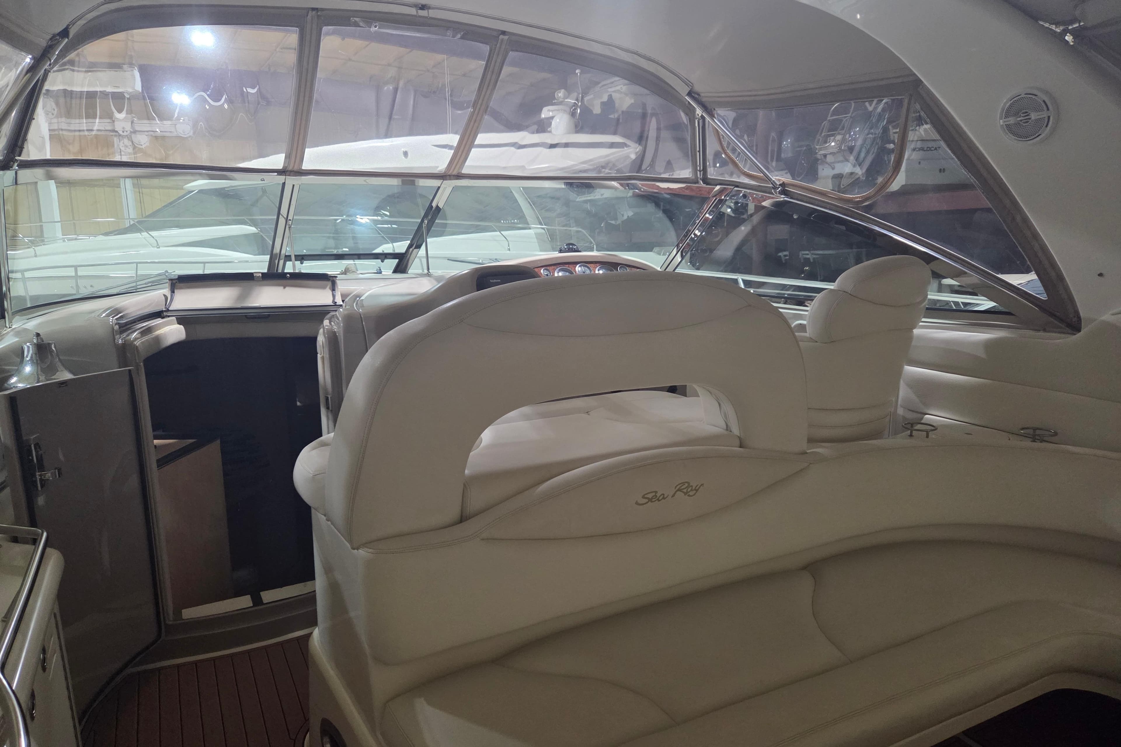 Interior of a 2000 Sea Ray 410 Sundancer yacht with luxurious seating and helm.