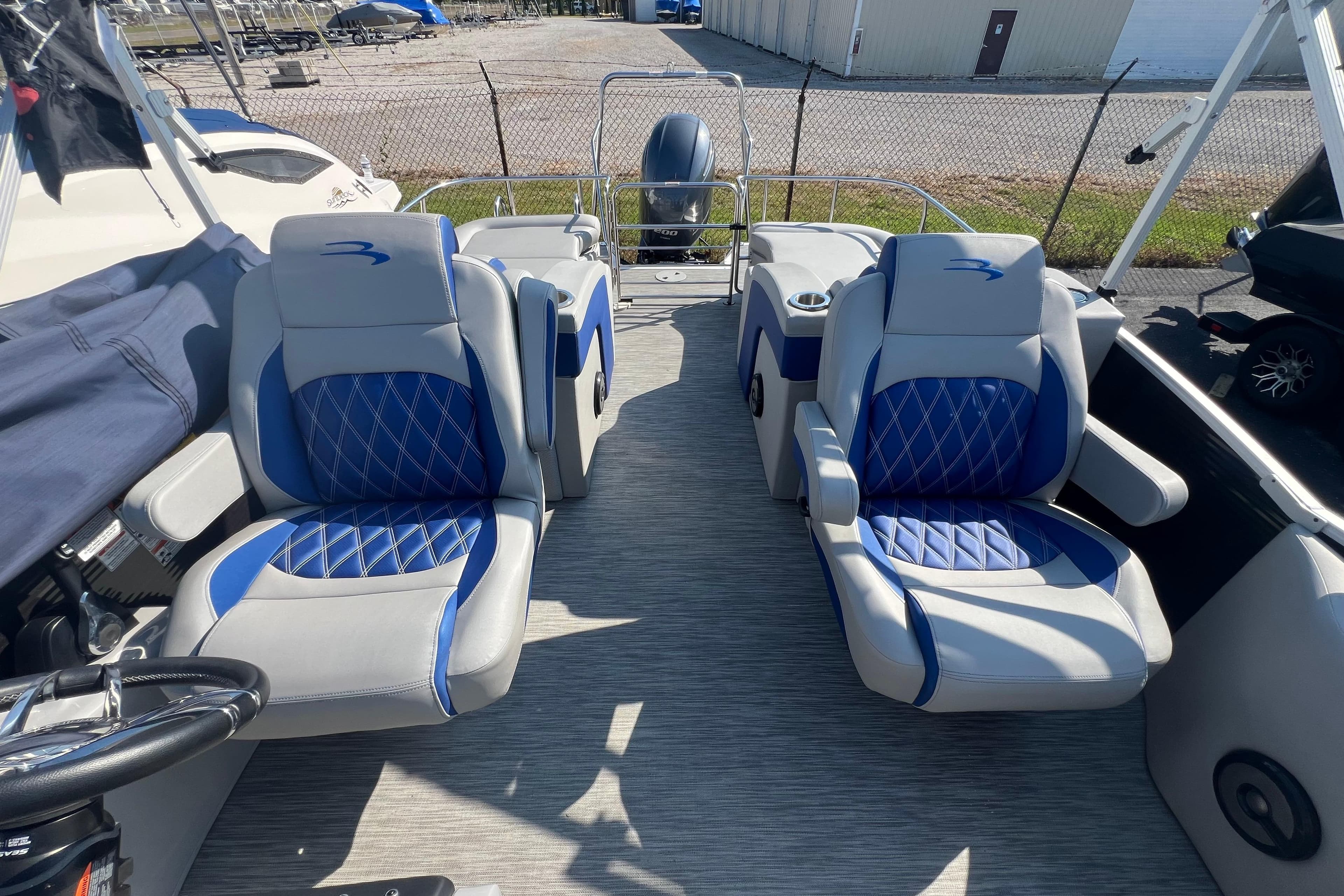 2021 Bennington Q 23 Swingback boat interior with blue and gray seating.