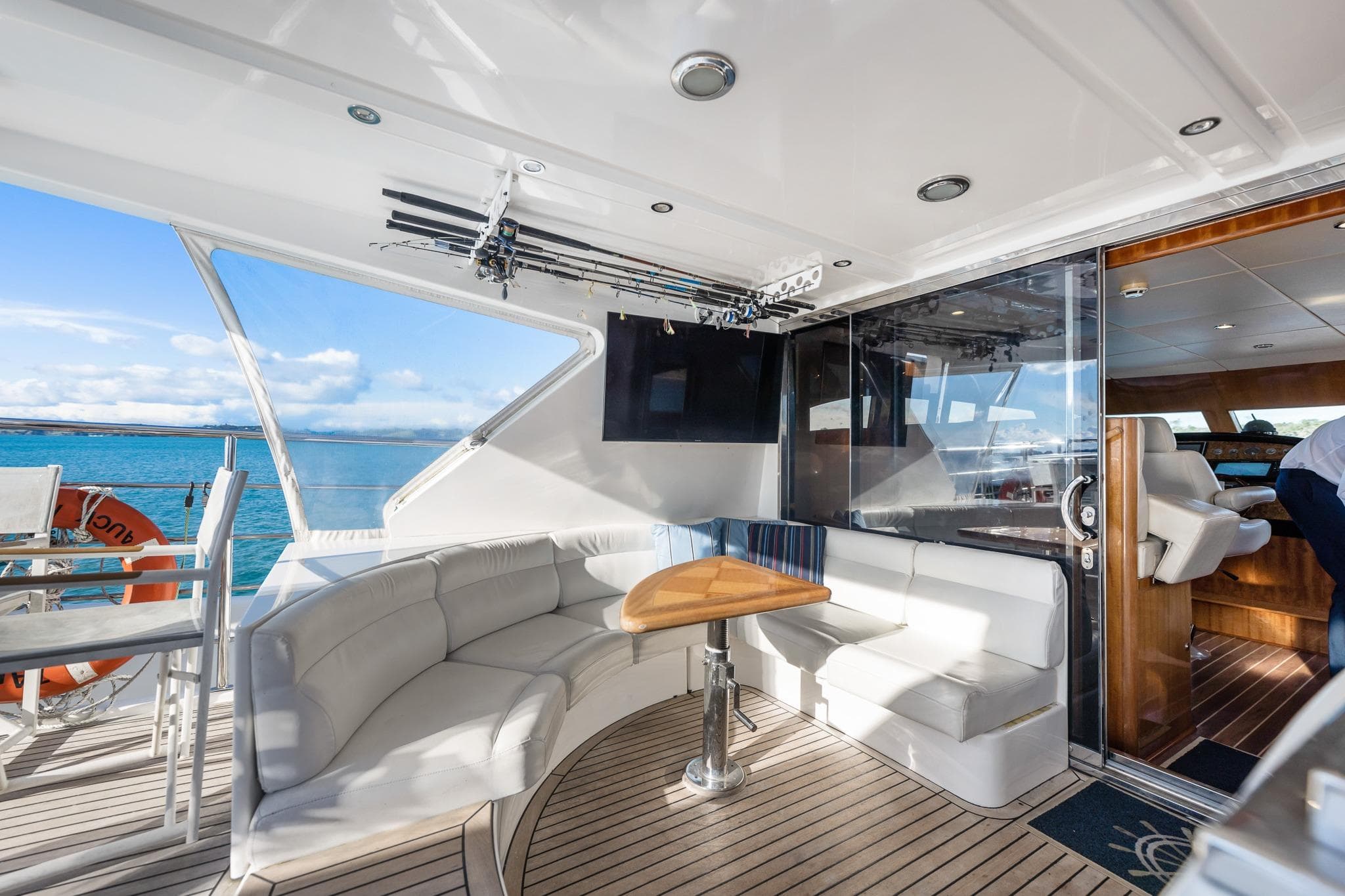 Luxurious 2008 Dyna Laguna 77 yacht interior with elegant seating and ocean view.