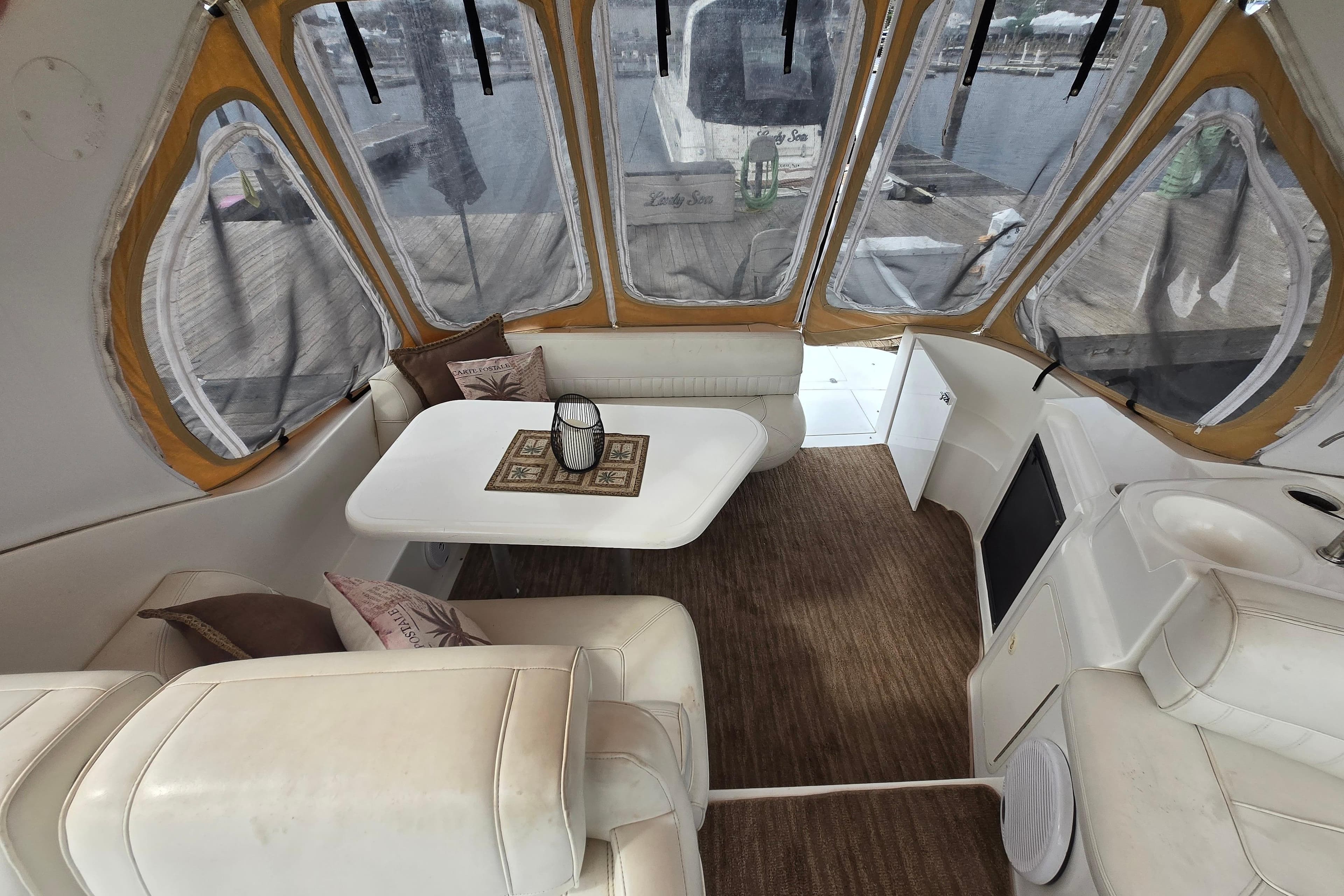 Interior of 2002 Cruisers Yachts 3372 Express with cozy seating and table.