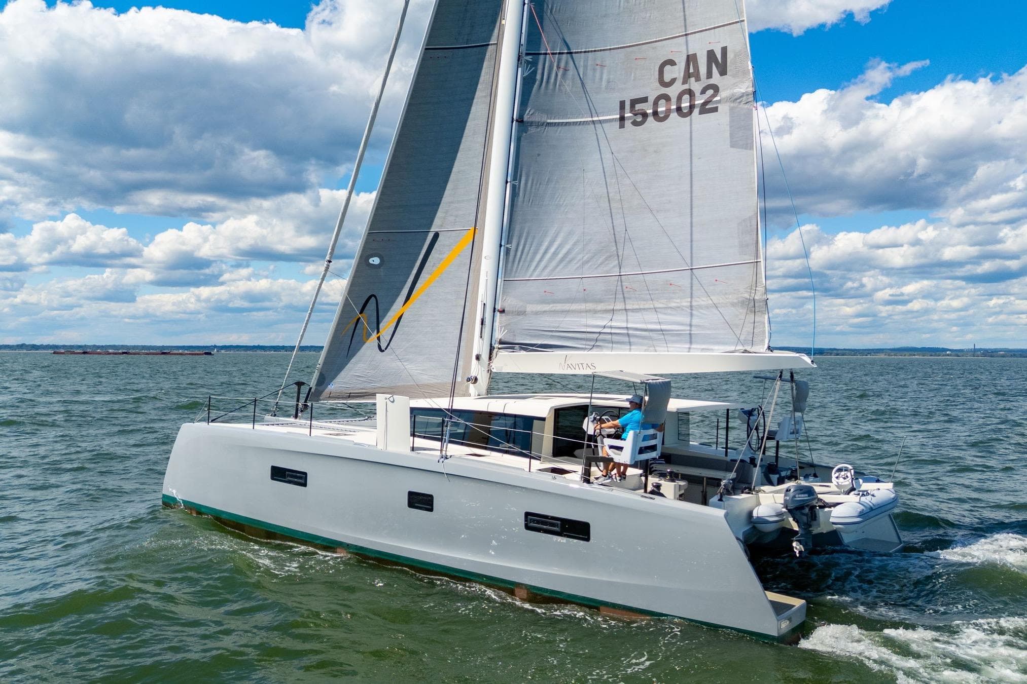 2019 Itacatamarans 14.99 sailing on open water under a cloudy sky.