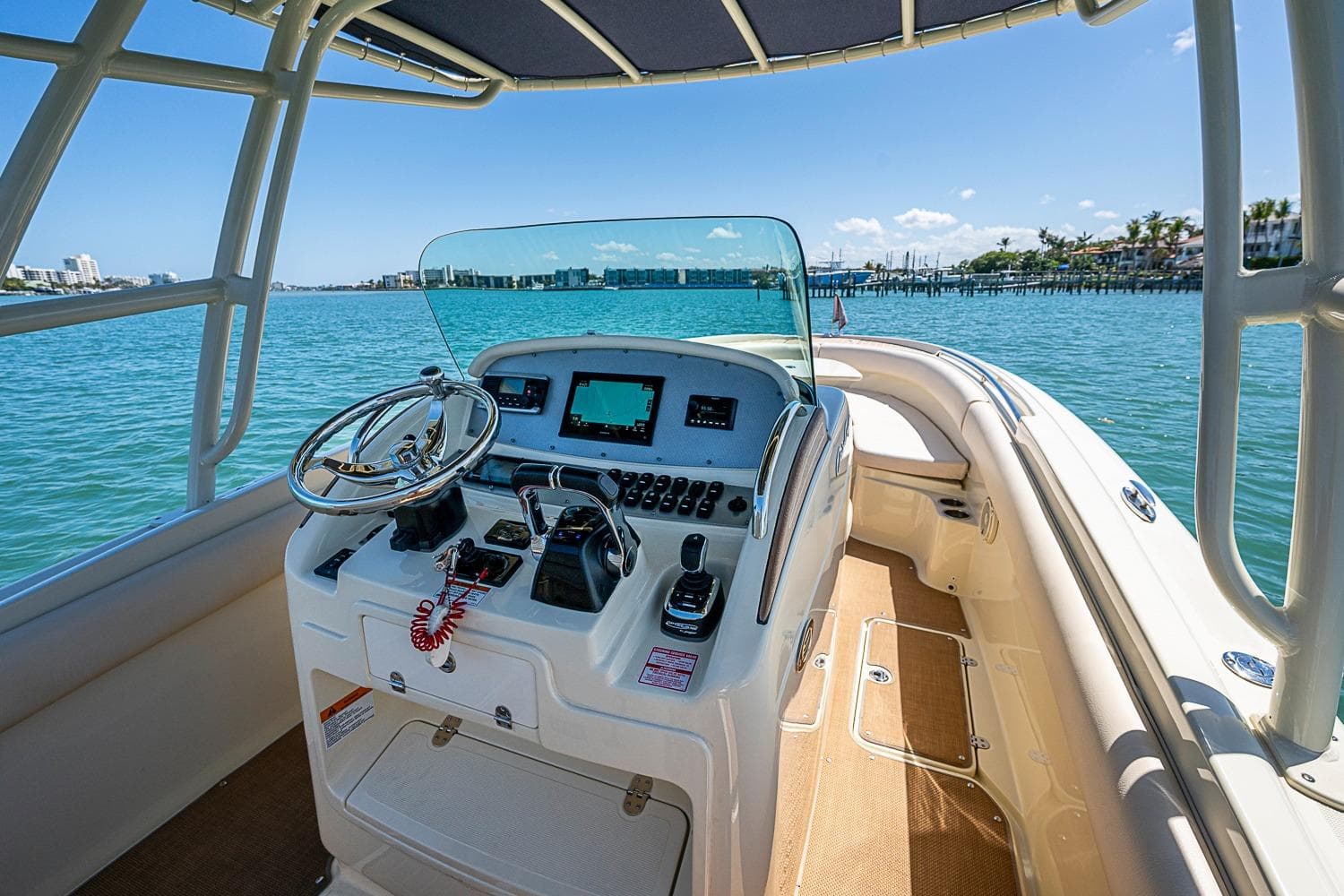 2017 Chris-Craft Catalina 26 boat cockpit with steering wheel and navigation controls.