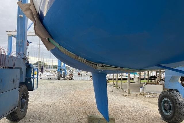 Catalina 36 MK I sailboat from 1986 on a lift at a marina.