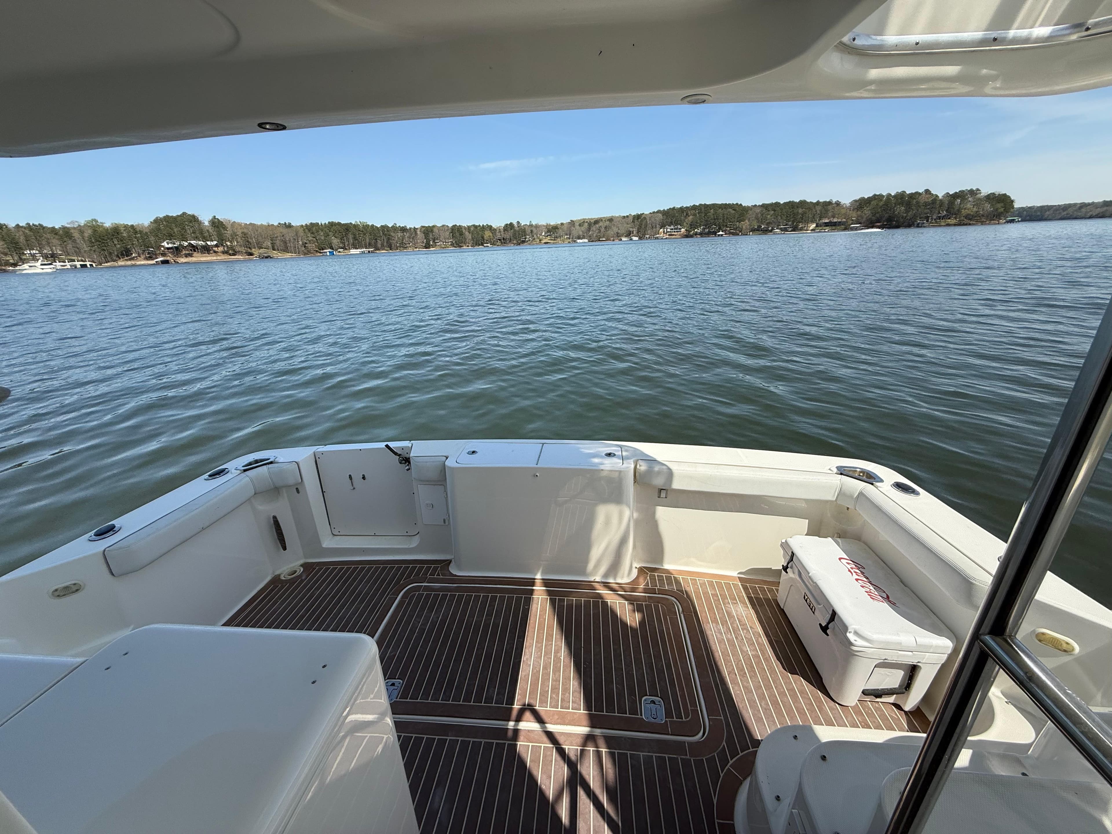 2007 Silverton 36 Convertible boat deck overlooking serene lake and forested shoreline.