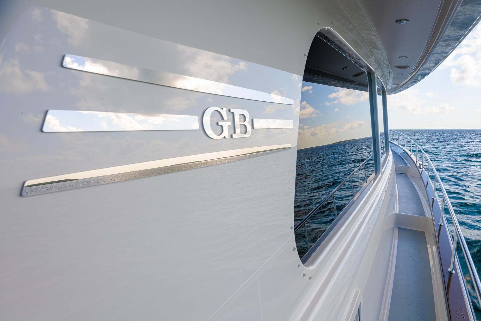 2026 Grand Banks GB 85 yacht on open water, sleek design, ocean reflection.