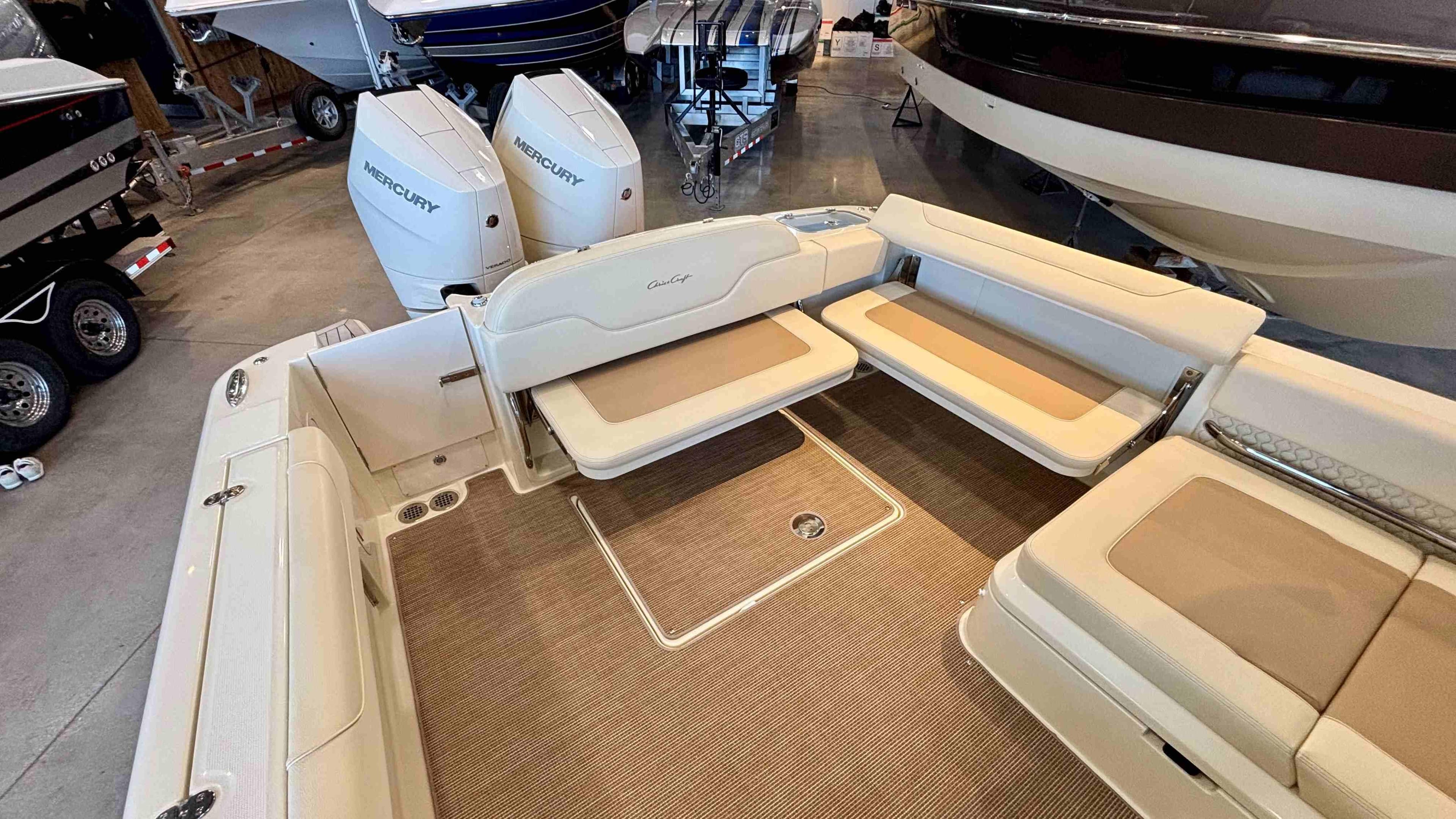 2024 Chris-Craft Calypso 32 CT boat interior with beige seating and Mercury engines.