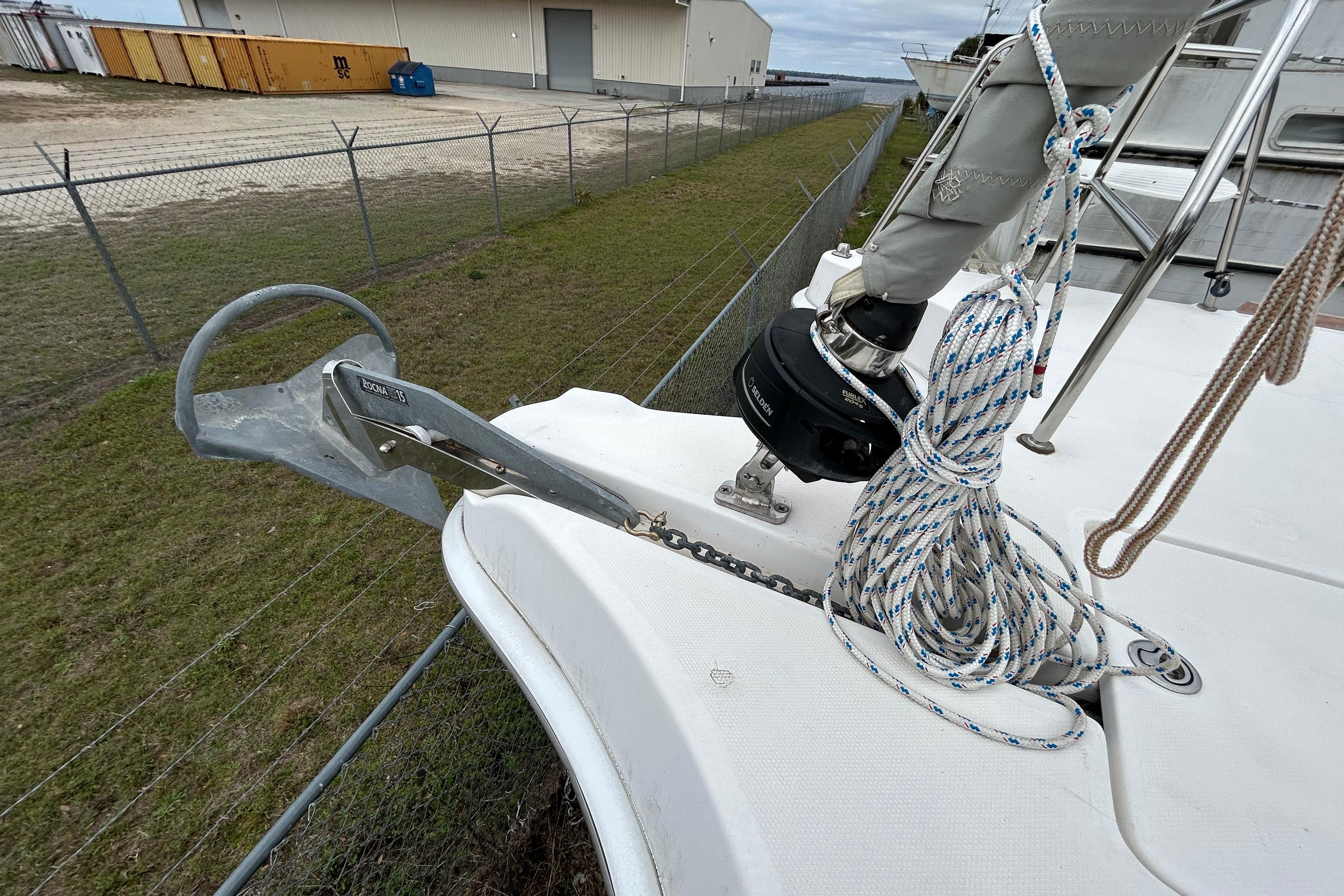 Bow of 2013 Gemini Legacy 35 sailboat with anchor and coiled rope.