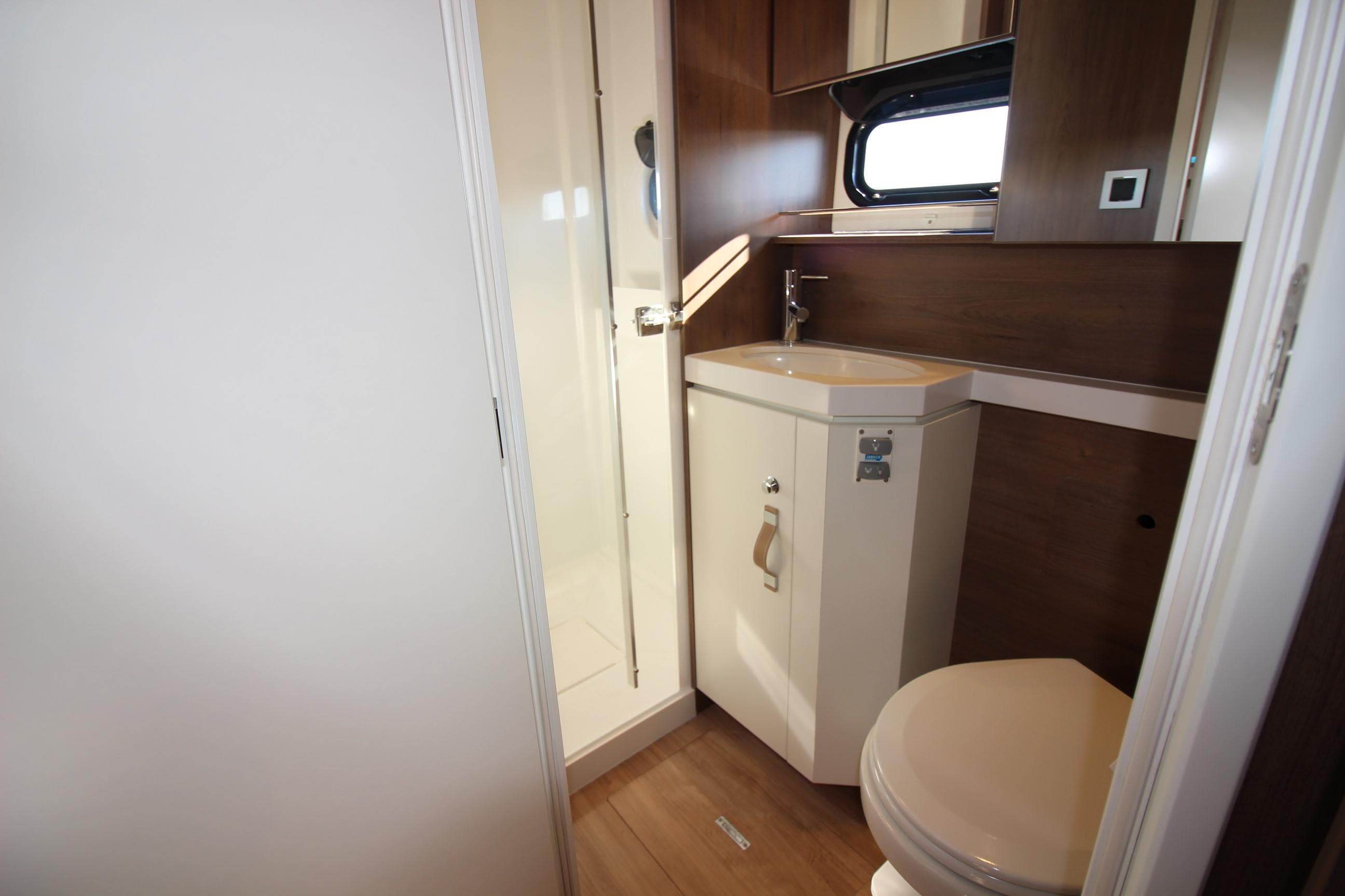 Modern bathroom in 2022 Bali 5.4 yacht with shower, sink, and toilet.