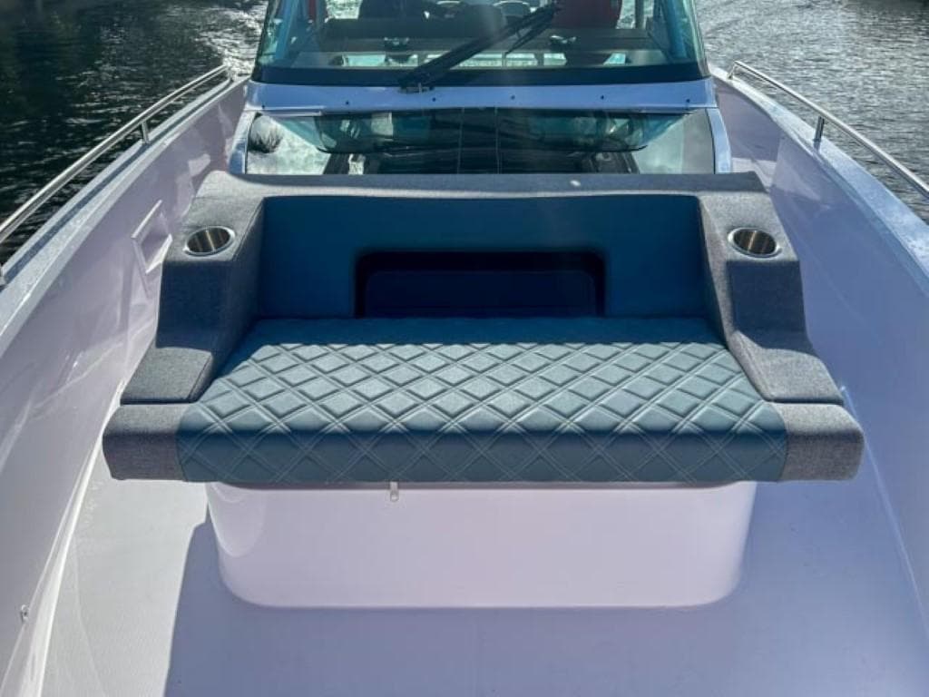 2024 Axopar 37 Sun Top boat with cushioned seating and cup holders.