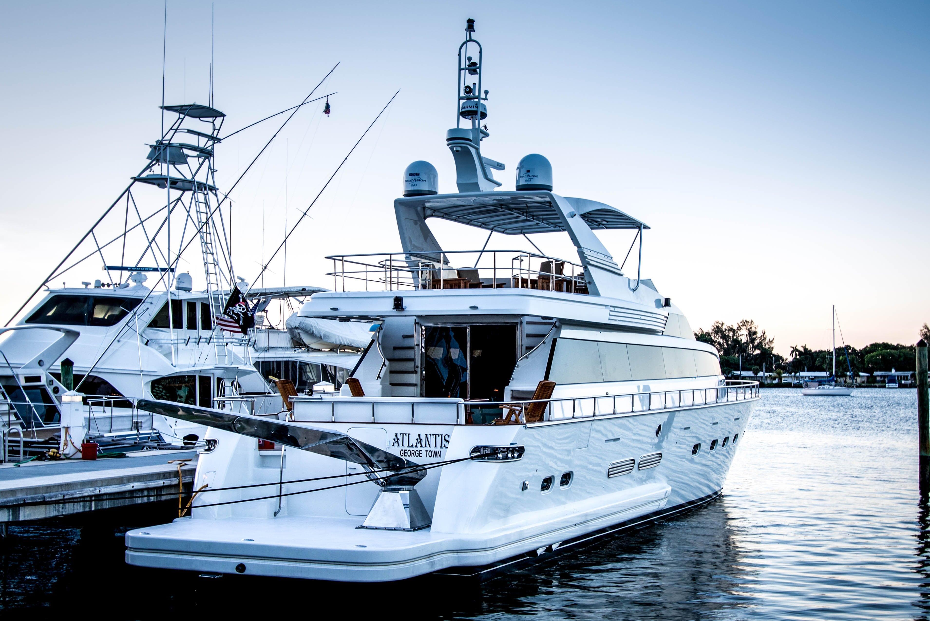 Luxury yacht Hershine Custom 87, 1996 model, docked at marina during sunset.
