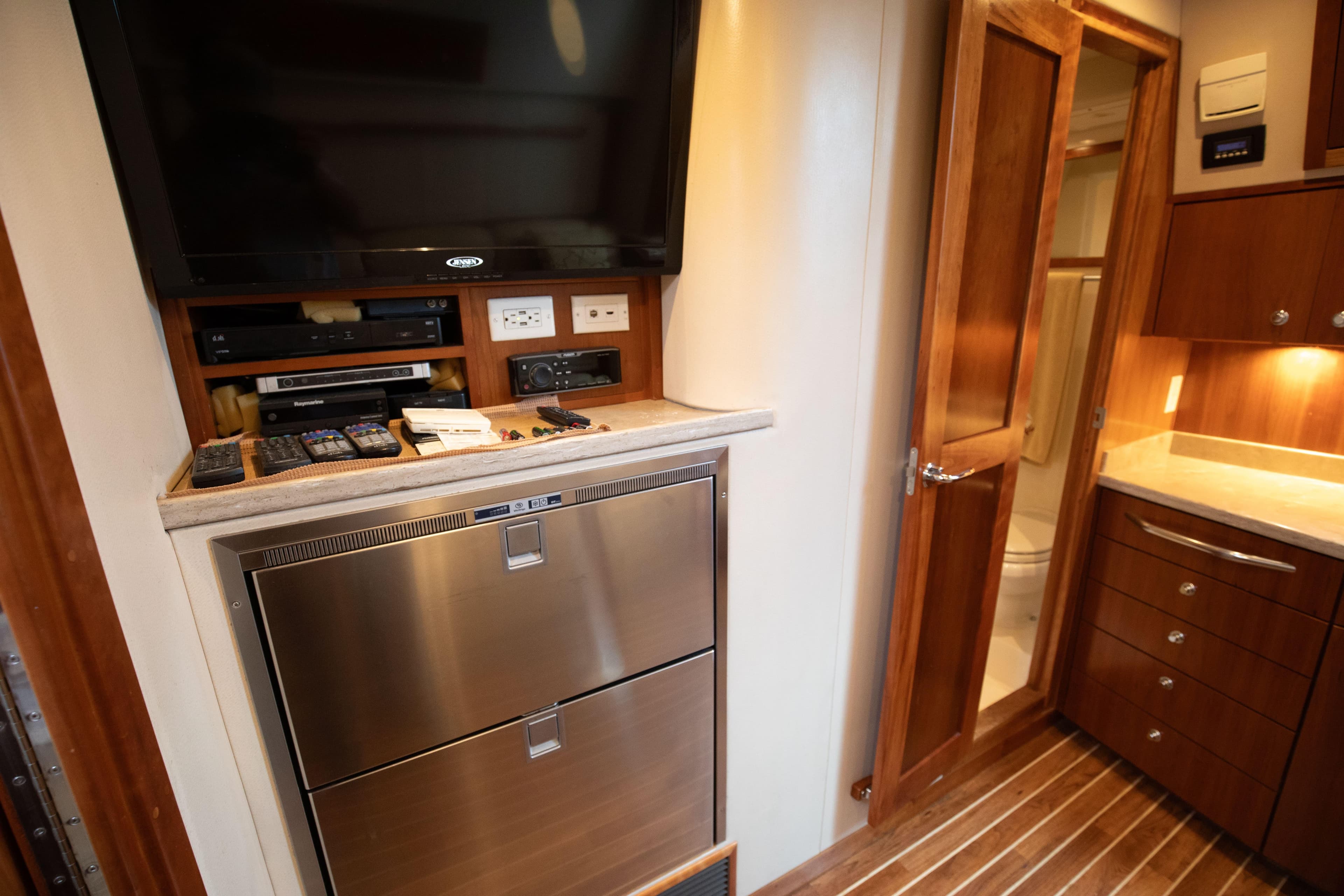 Interior of 2015 Albemarle 360 Express Fisherman with TV, appliances, and wooden cabinetry.