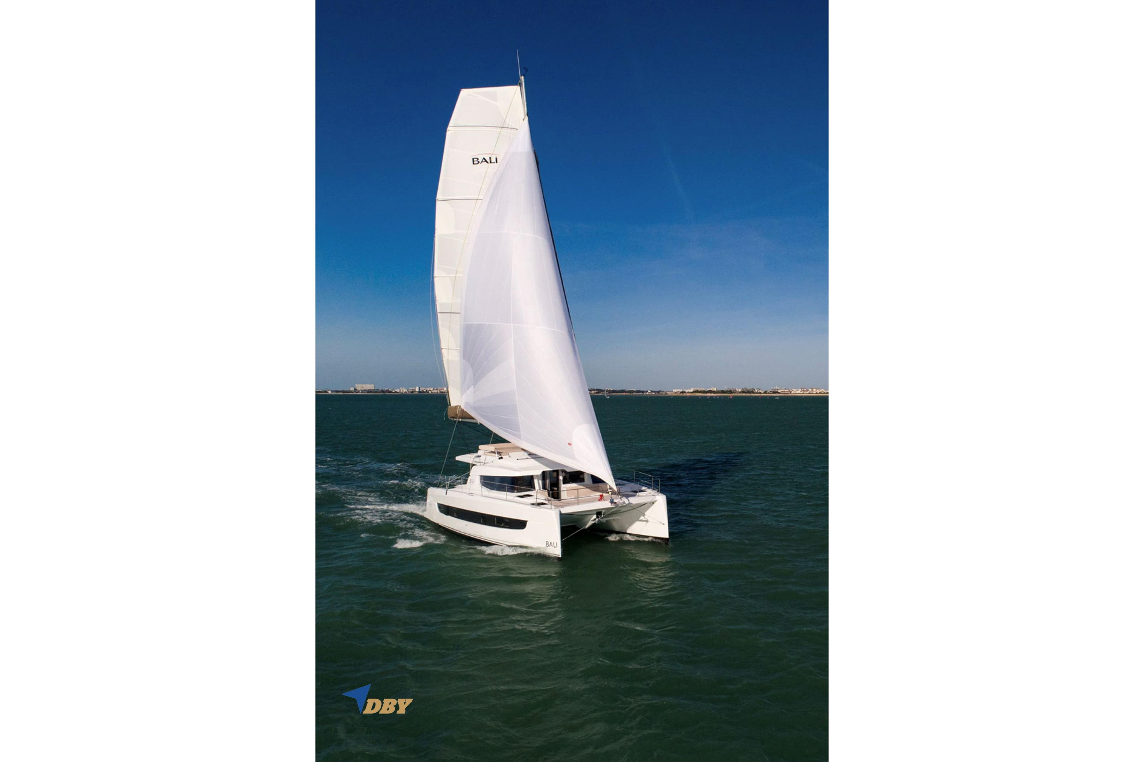 Sailing catamaran Bali 4.4, 2025 model, cruising on open water under clear blue skies.