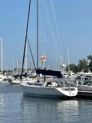 Sailboat Carroll Marine 45' Frers 45, 1990, docked in a marina under clear blue sky.