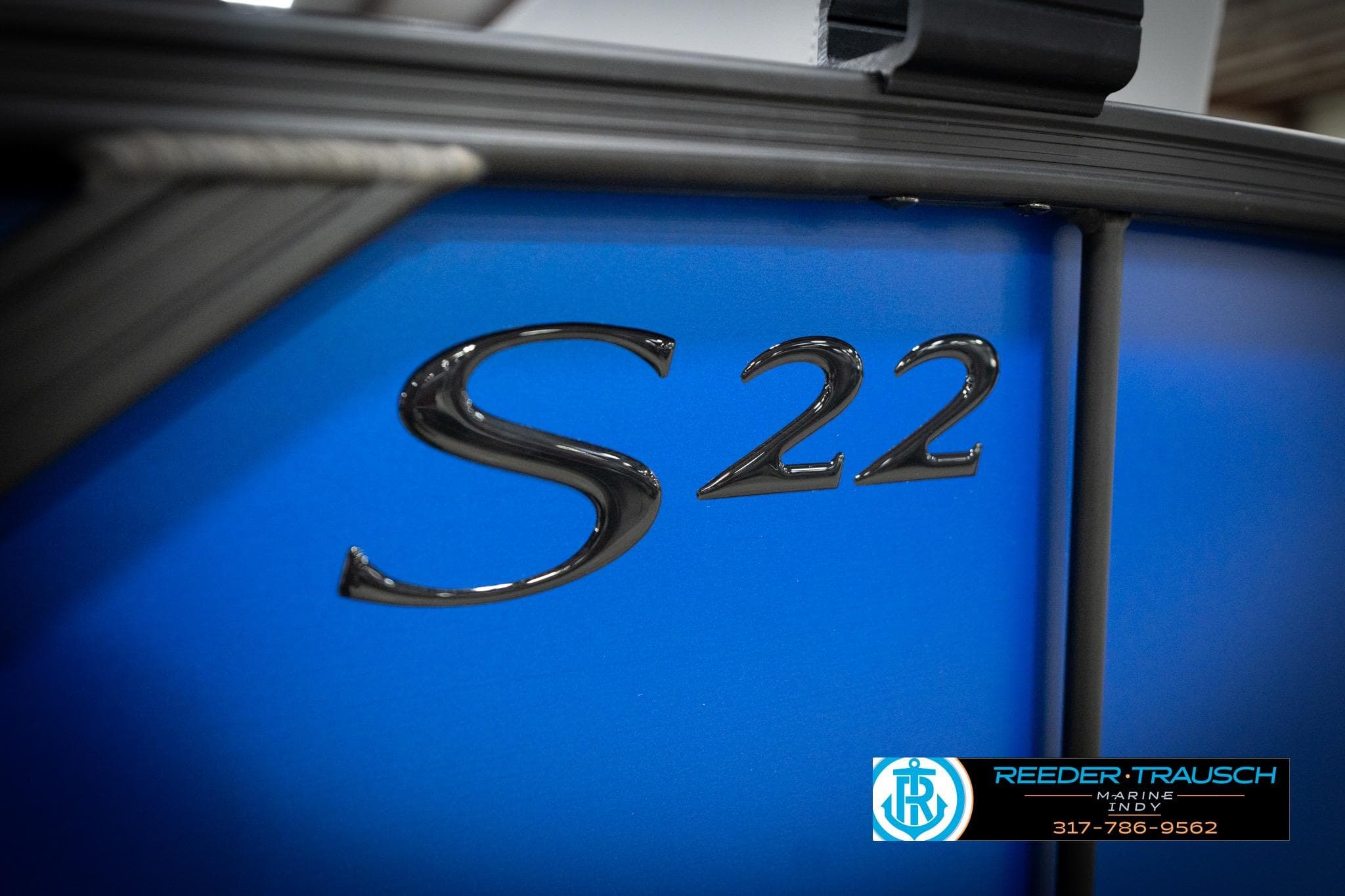 2026 Bennington 22 SSB boat, blue exterior with "S 22" emblem, Reeder-Trausch Marine logo.