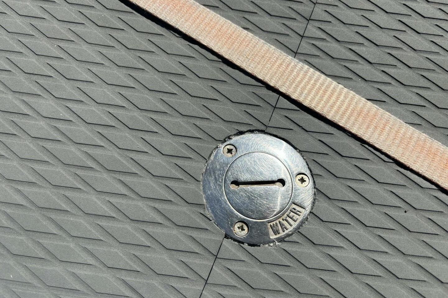 Textured deck of 2009 Class 40 Akilaria RC2 with water access cap.