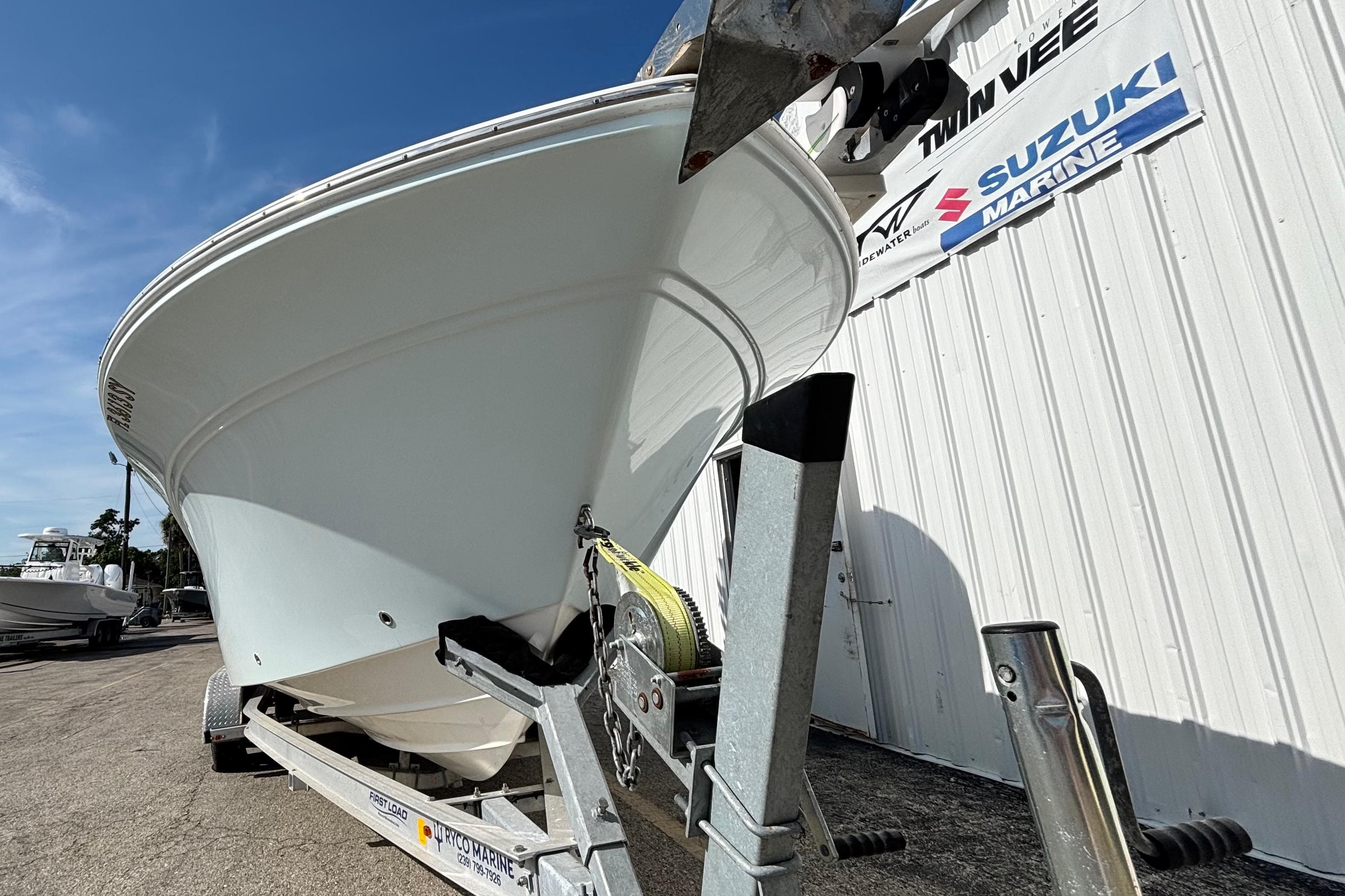 2021 Sea Fox 249 Avenger boat on trailer outside marine dealership.