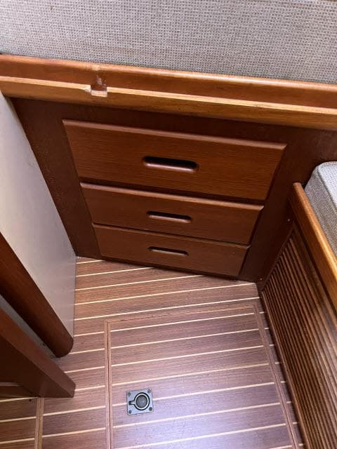Wooden interior drawers on 1999 Grand Banks Eastbay 38 yacht with striped flooring.
