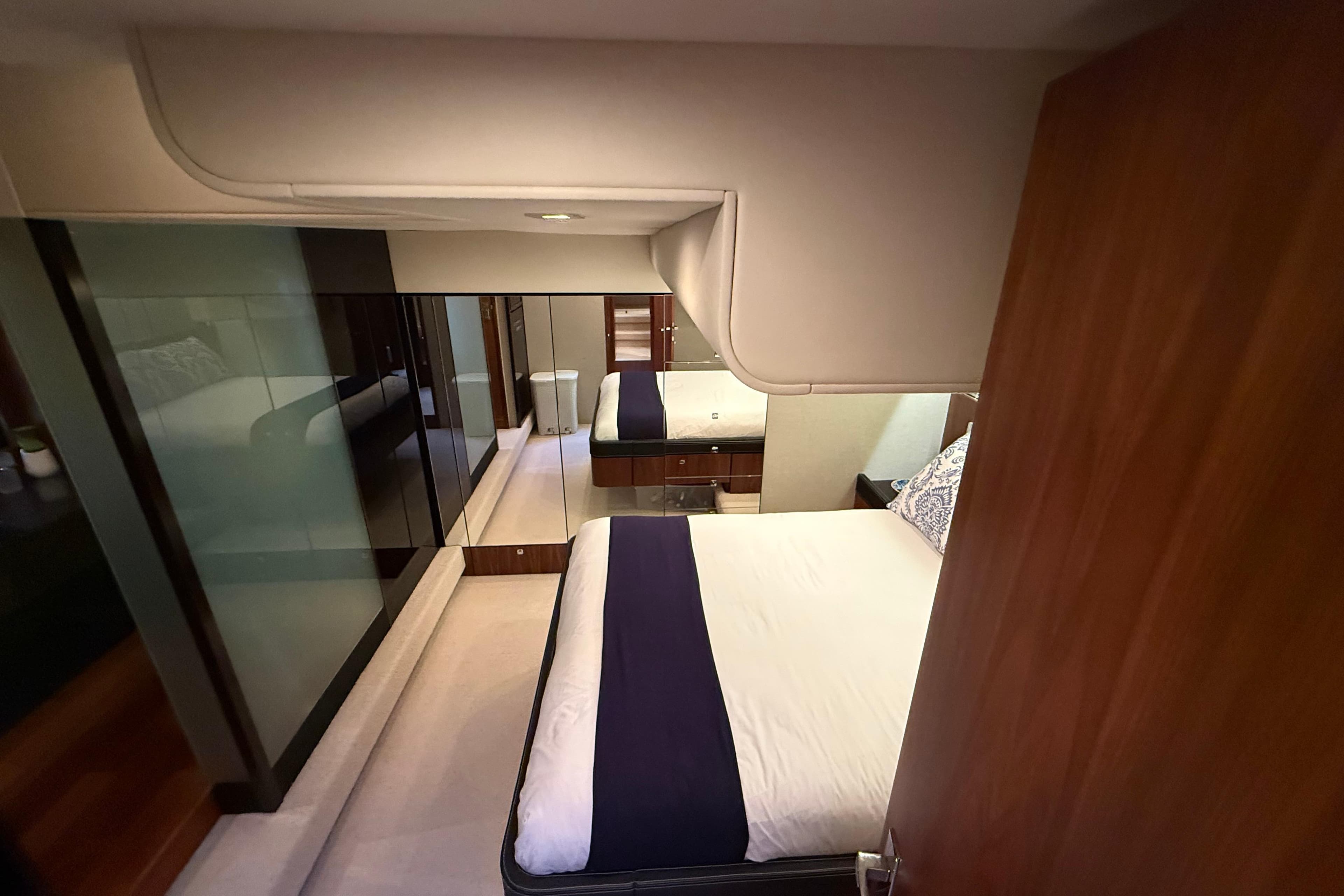 Luxurious bedroom interior of 2012 Fairline Squadron 58 yacht, featuring elegant design and modern amenities.