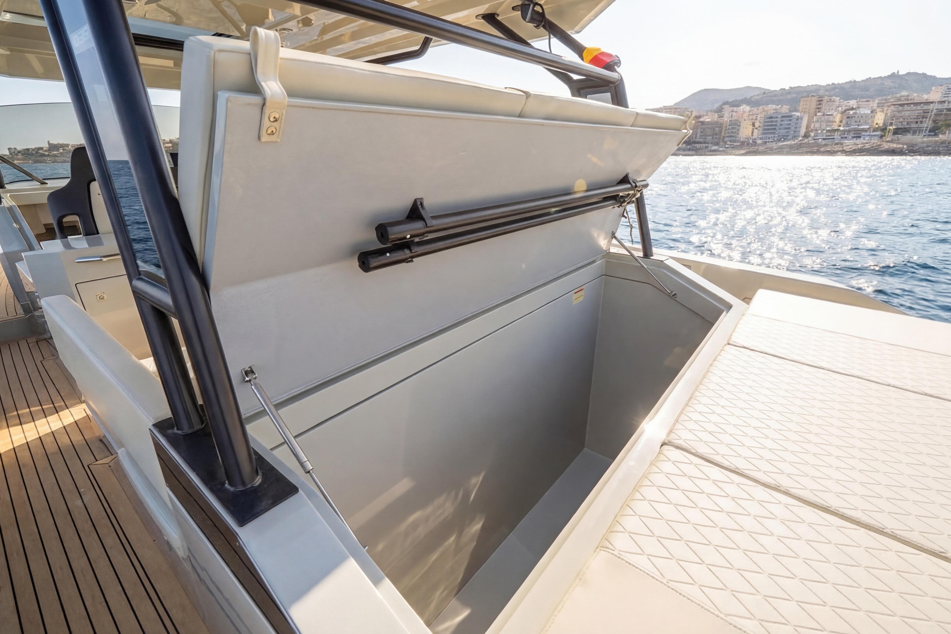 2025 De Antonio Yachts D36 storage compartment open on deck, with scenic ocean view.