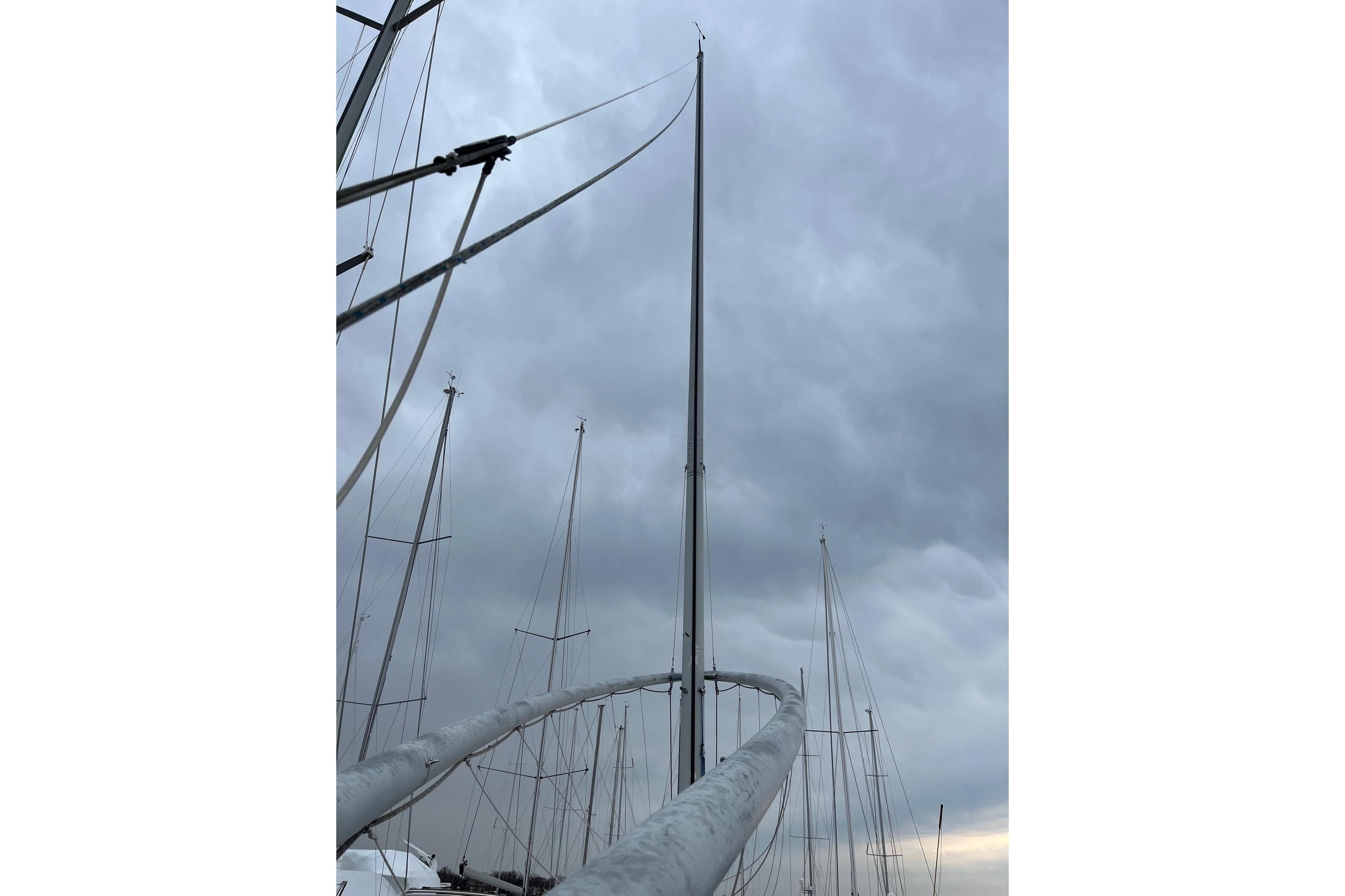 1980 Hinterhoeller Nonsuch 30 Classic sailboat mast against cloudy sky.
