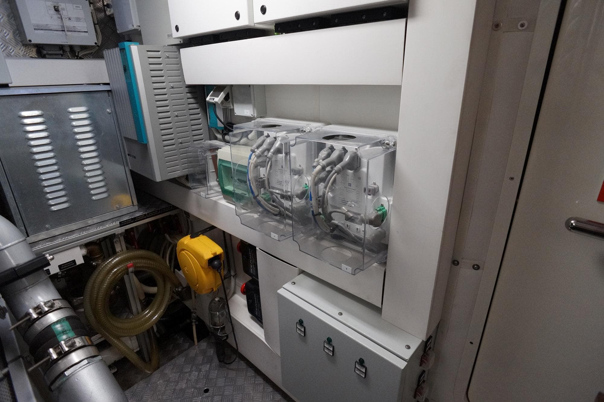 Engine room of 2016 Pershing 70 yacht, showcasing advanced machinery and equipment.