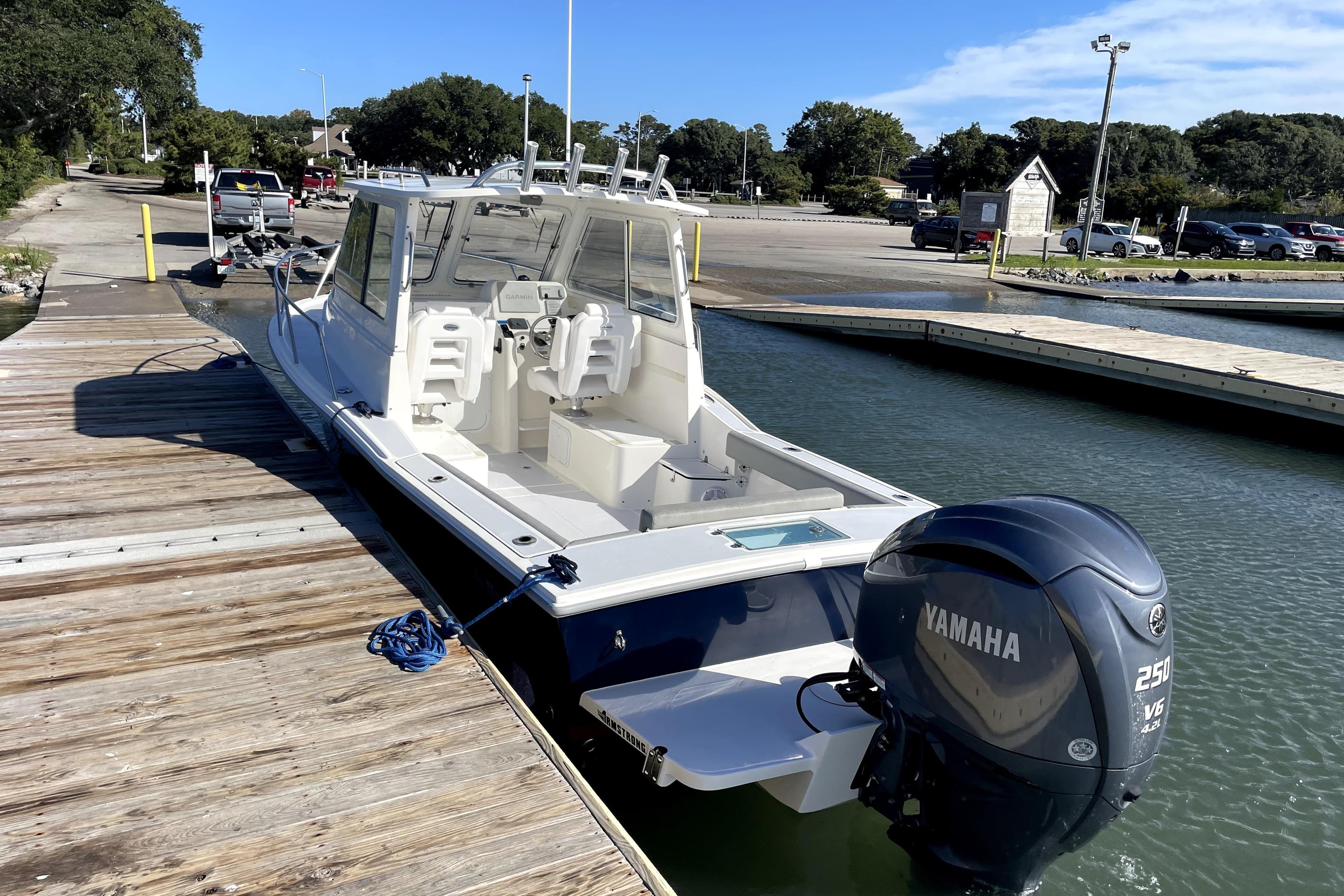 2024 NorthCoast 235 boat docked with Yamaha 250 V6 engine, sunny day.