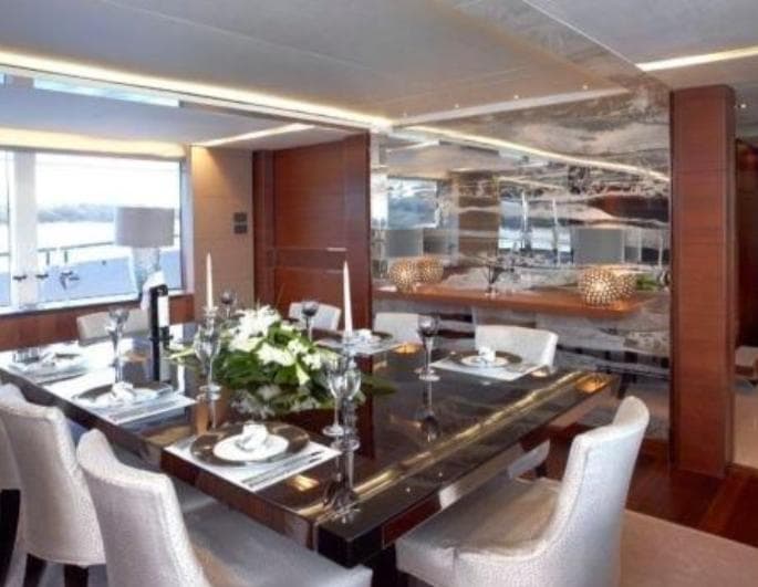 Luxurious dining area on a 2012 Princess 40M yacht, featuring elegant decor and table settings.