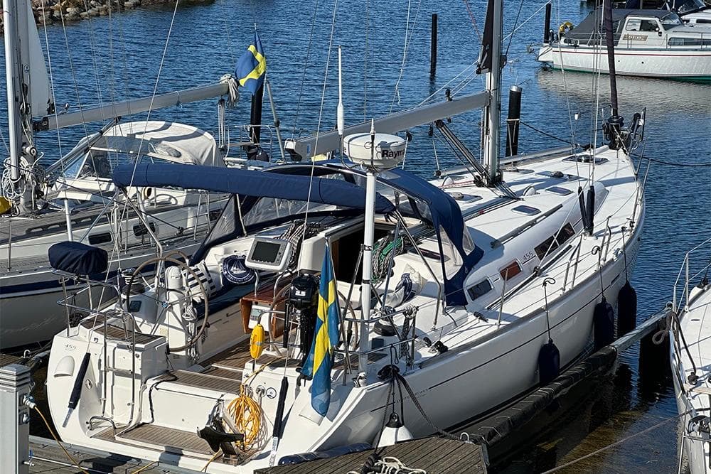 2007 Dufour 455 GL sailboat docked in marina with Swedish flag.