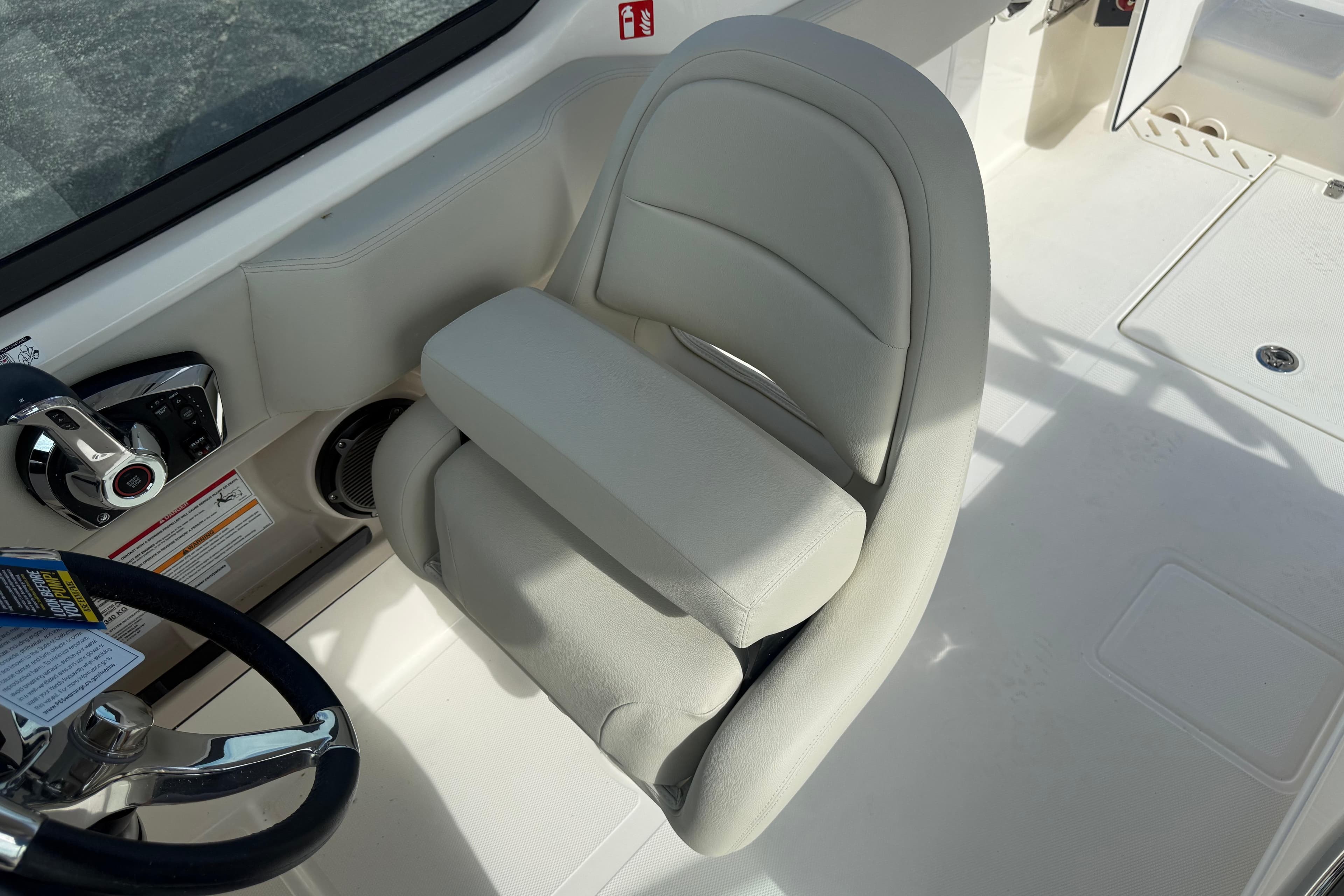 Captain's seat on 2026 Boston Whaler 240 Vantage boat, featuring sleek design and controls.