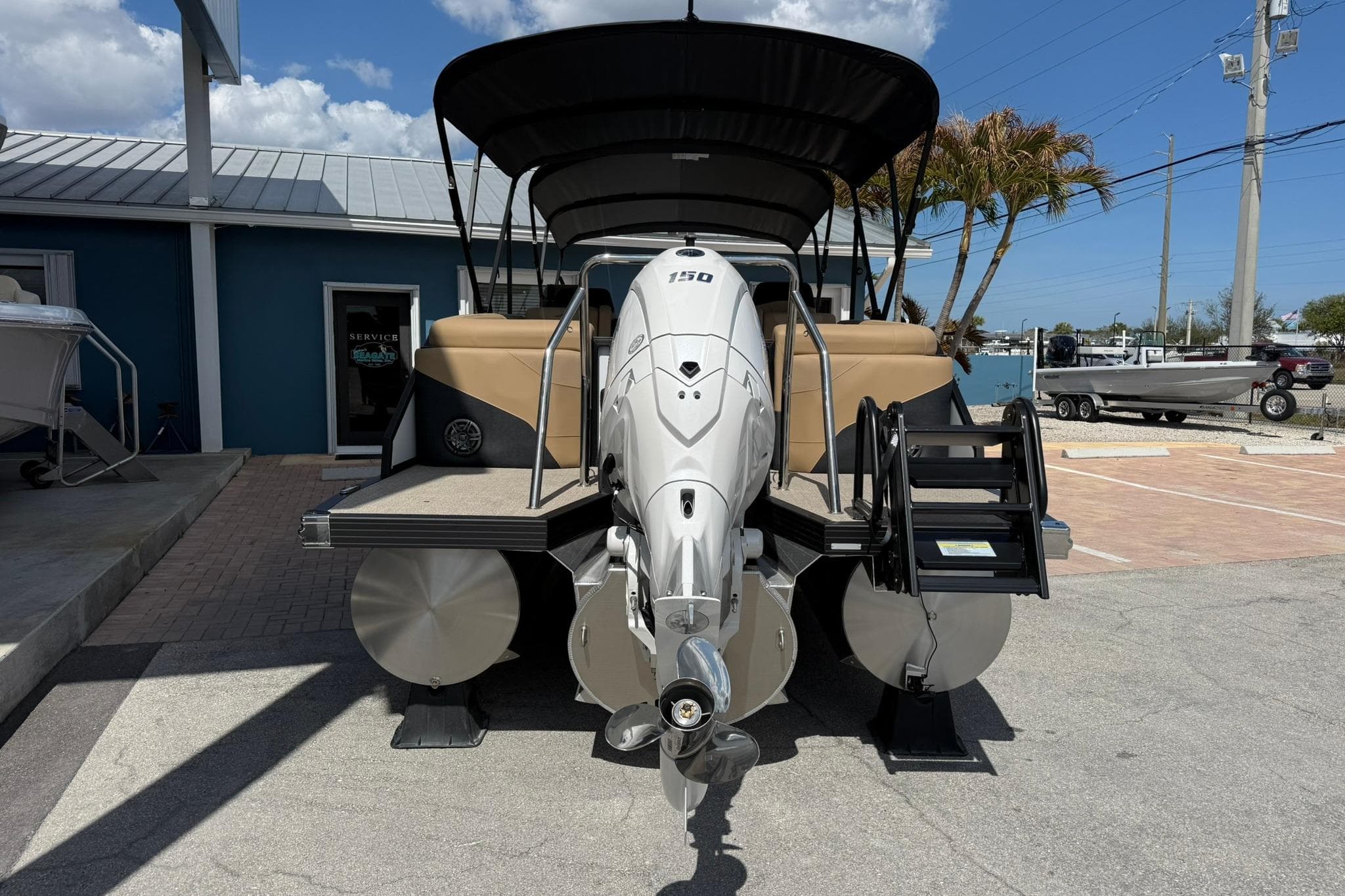 2026 Evotti 523QL boat with powerful outboard motor, docked under clear blue sky.