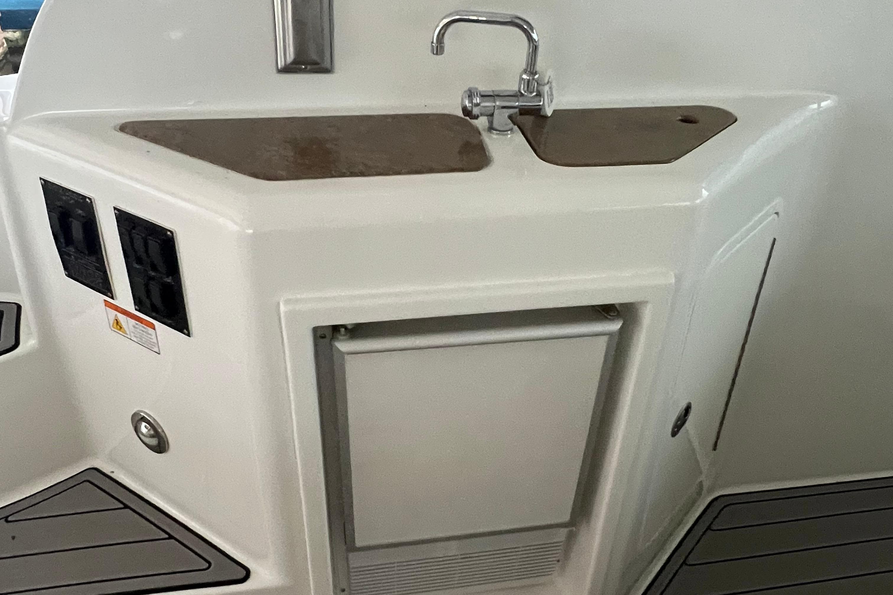 2008 Cruisers Yachts 390 Sports Coupe kitchenette with sink and storage.