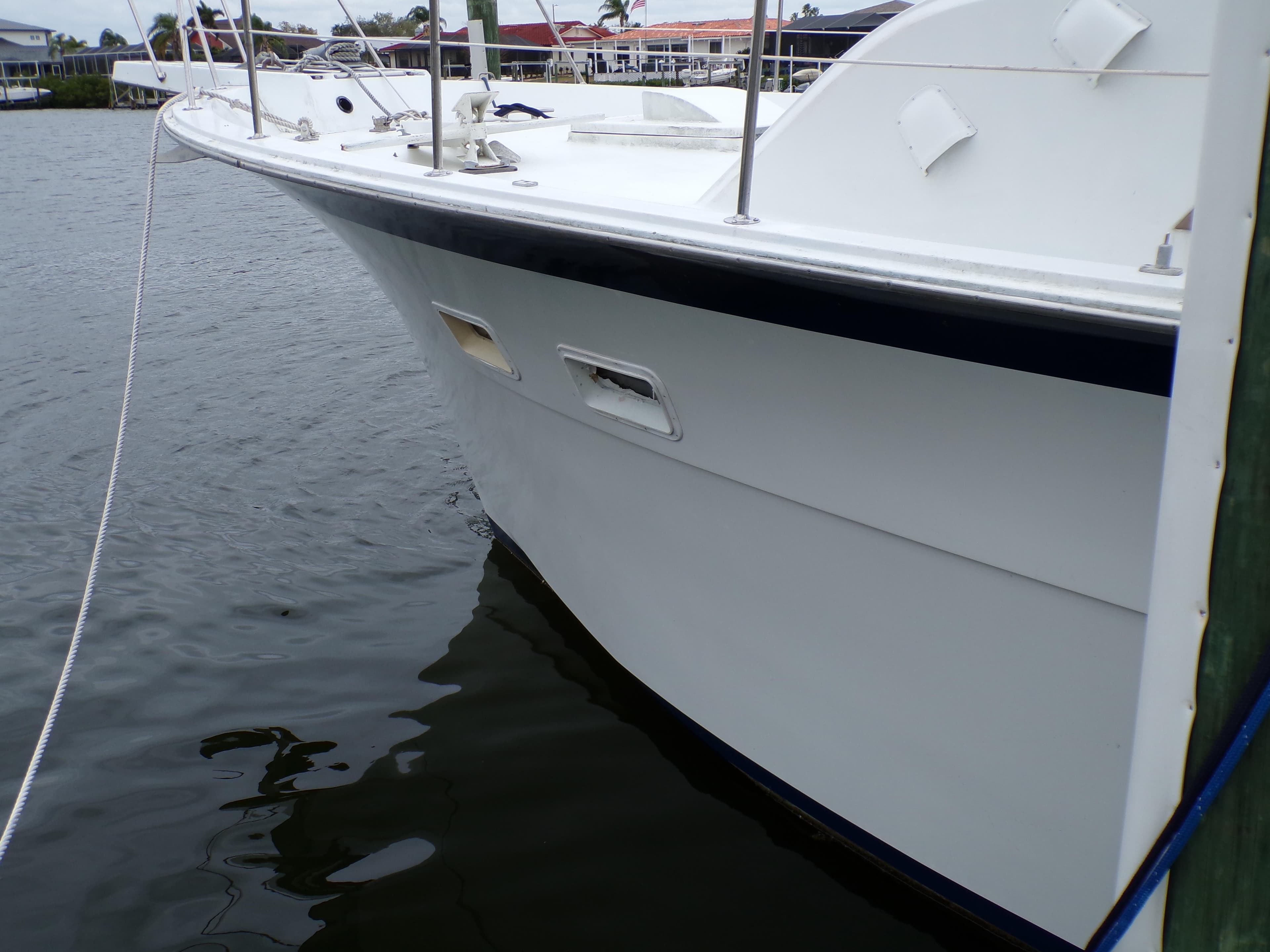 1978 Hatteras 58 Yacht Fisherman docked on calm water.