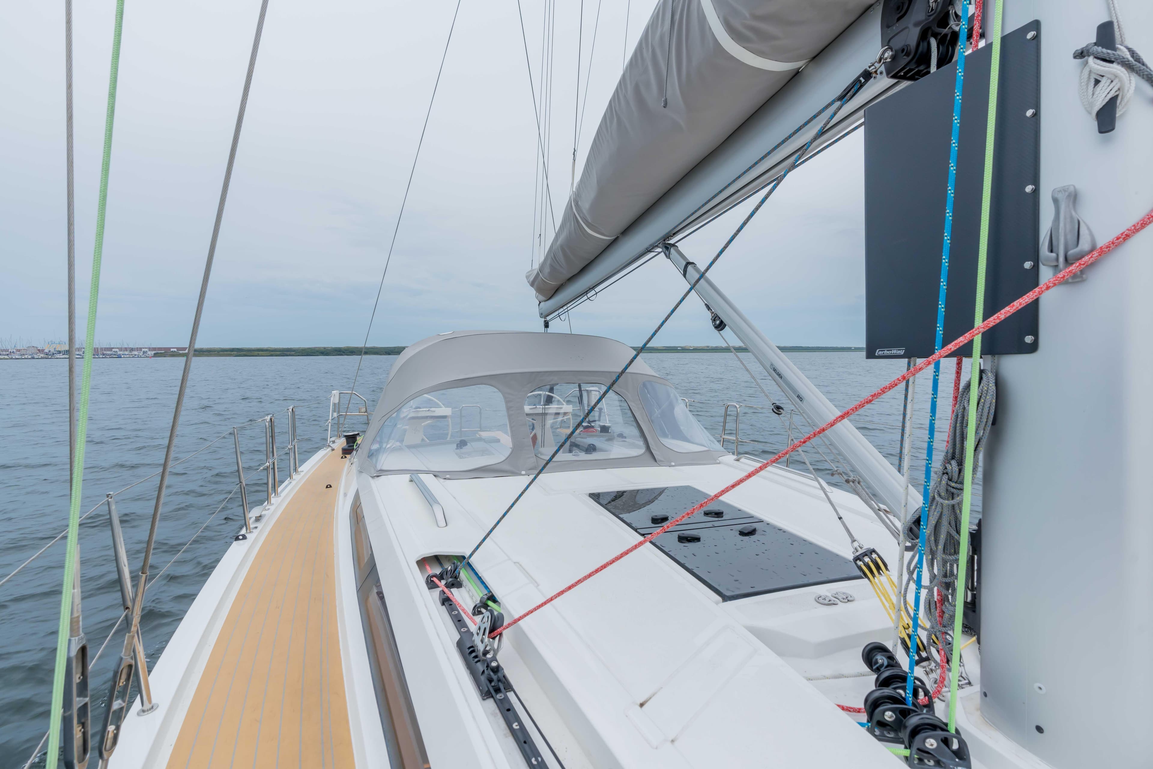 Italia Yachts 12.98 sailboat, 2023 model, on calm waters with visible deck and rigging.
